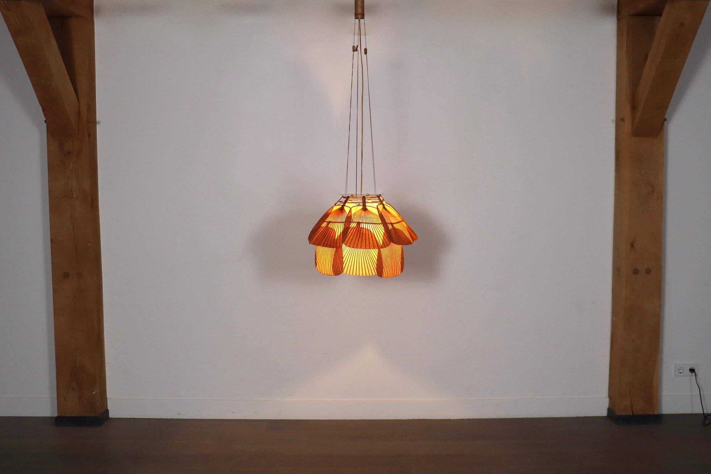 This extremely rare, exquisite hanging lamp, Ju-Yon, is a part of Ingo Maurer’s Uchiwa series, designed for Design M in 1974, which epitomizes the dynamic and innovating essence of 1970s design.

This model, named Ju-Yon, features fourteen delicate