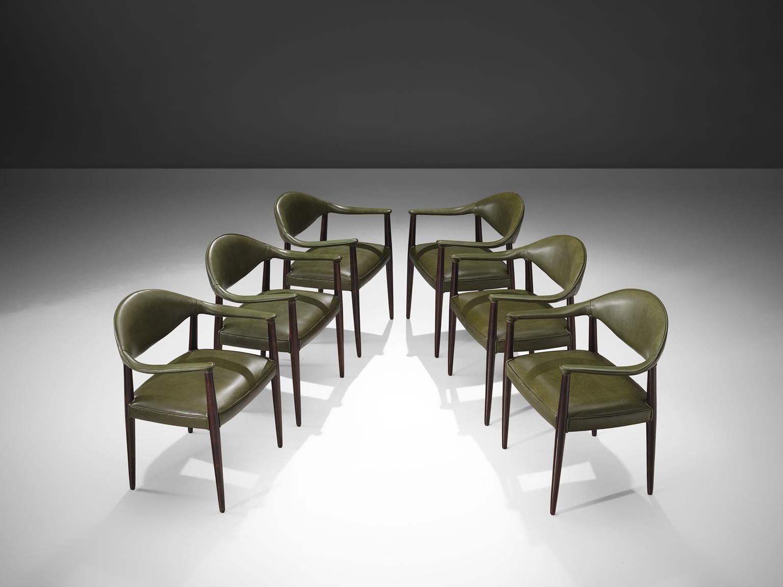 Juan Gamboa, six dining chairs, green leather and mahogany, Spain, 1960s.

This set of six grand armchairs are designed by Jean Gamboa. The olive green luxurious leather is still original and therefore shows signs of age and wear that enrich the