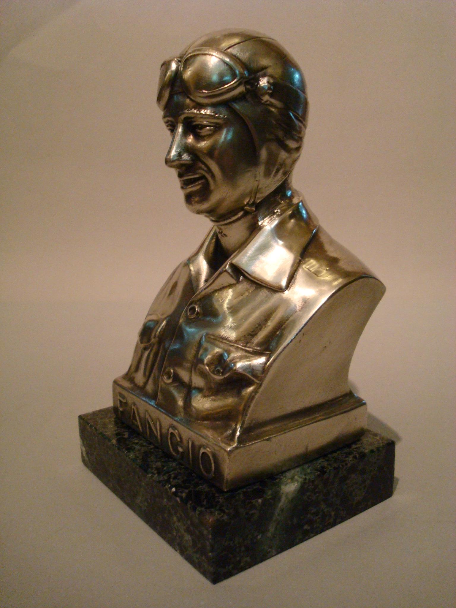 Juan Manuel Fangio silver plated statue with marble base. Made in Argentina, paperweight, circa 1950s. Very nice item to decorate a Automobilia fan´s desk.
Juan Manuel Fangio De´ramo (24 June 1911–17 July 1995), nicknamed El Chueco (