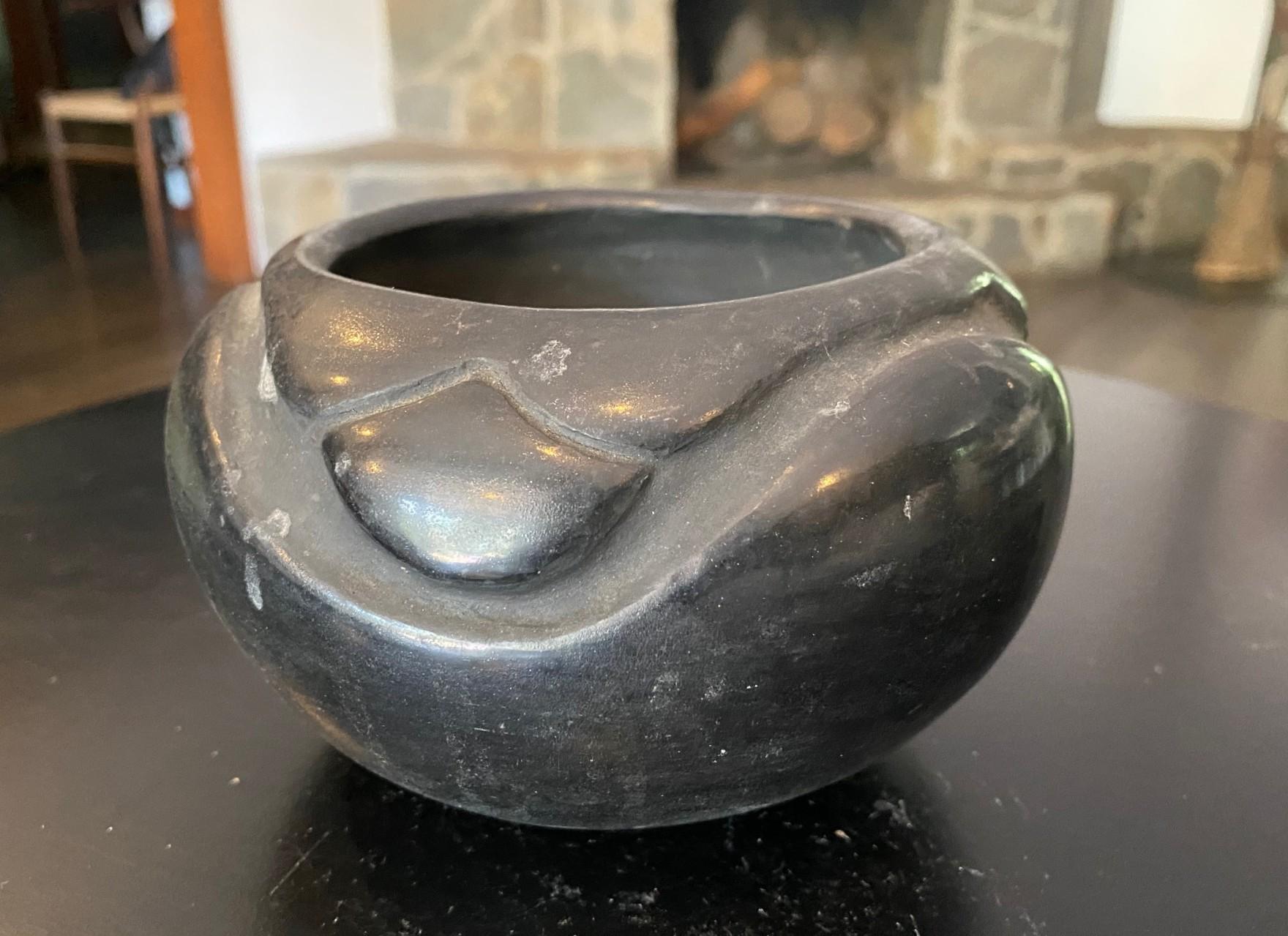 A beautiful and somewhat rare San Ildefonso Pueblo (Santa Fe, New Mexico) blackware (black on black ware) pottery bowl/vase by Juanita Montoya Pena (1900-1987), wife of potter Tony Pena and the youngest sister of Maria Martinez, one of the most