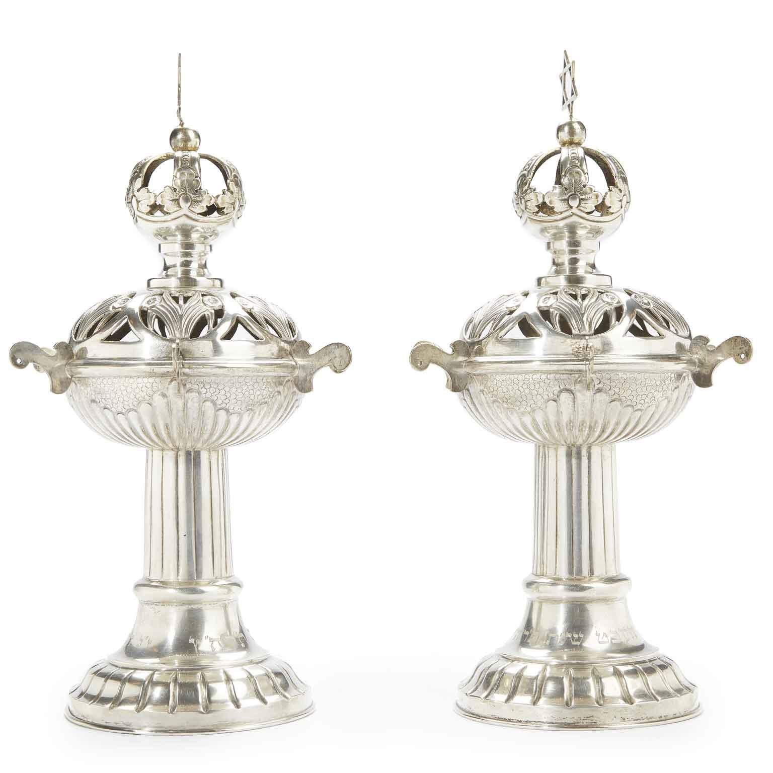 From Czech Republica pair of silver Torah finials Rimonim, the spherical bodies pierced and repoussé with foliage and bouches of flowers décor, surmounted by star of David finials. Circular ribbed pedestal bases with Hebrew dedication around foot