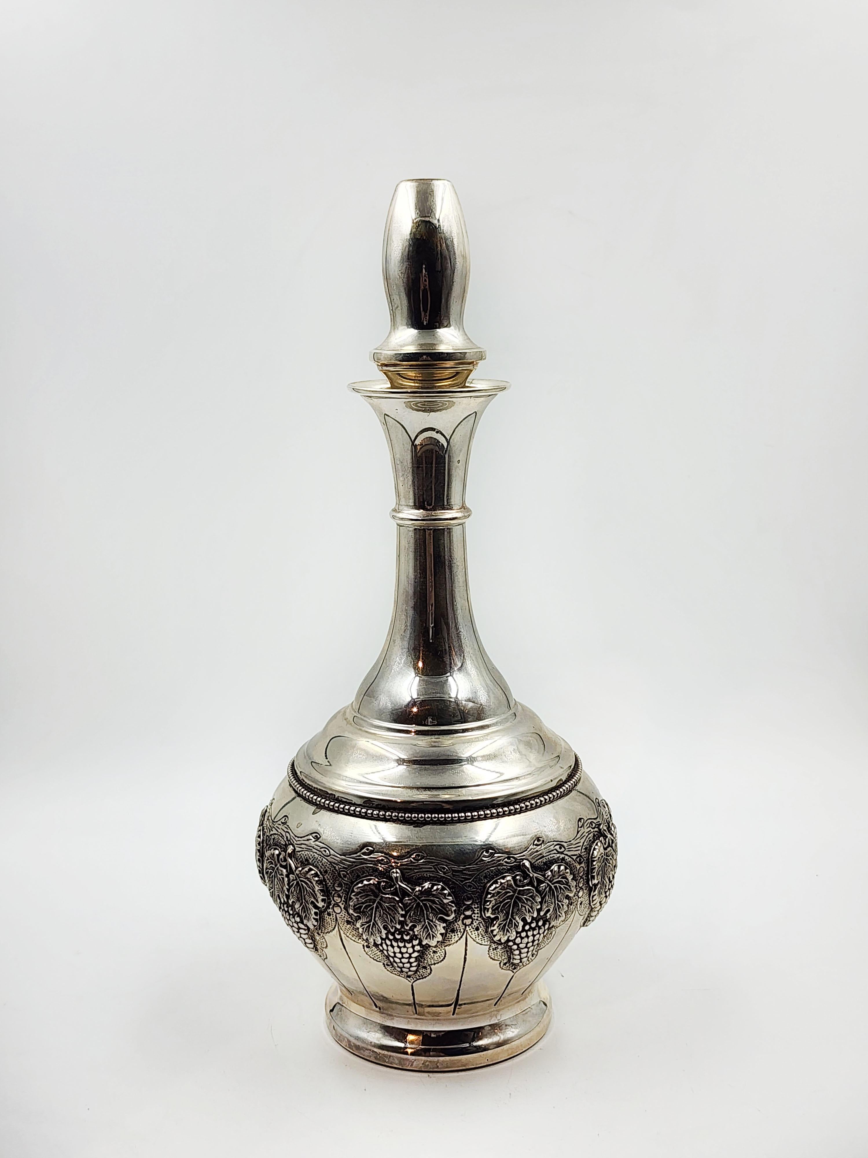 Judaica silver liquor bottle by HAZORFIM
Beautiful silver bottle with a thin neck that widens towards the base, it has an ornamental design of bunches of grapes
Measures:
Height:14.5cm
Diameter:10.5