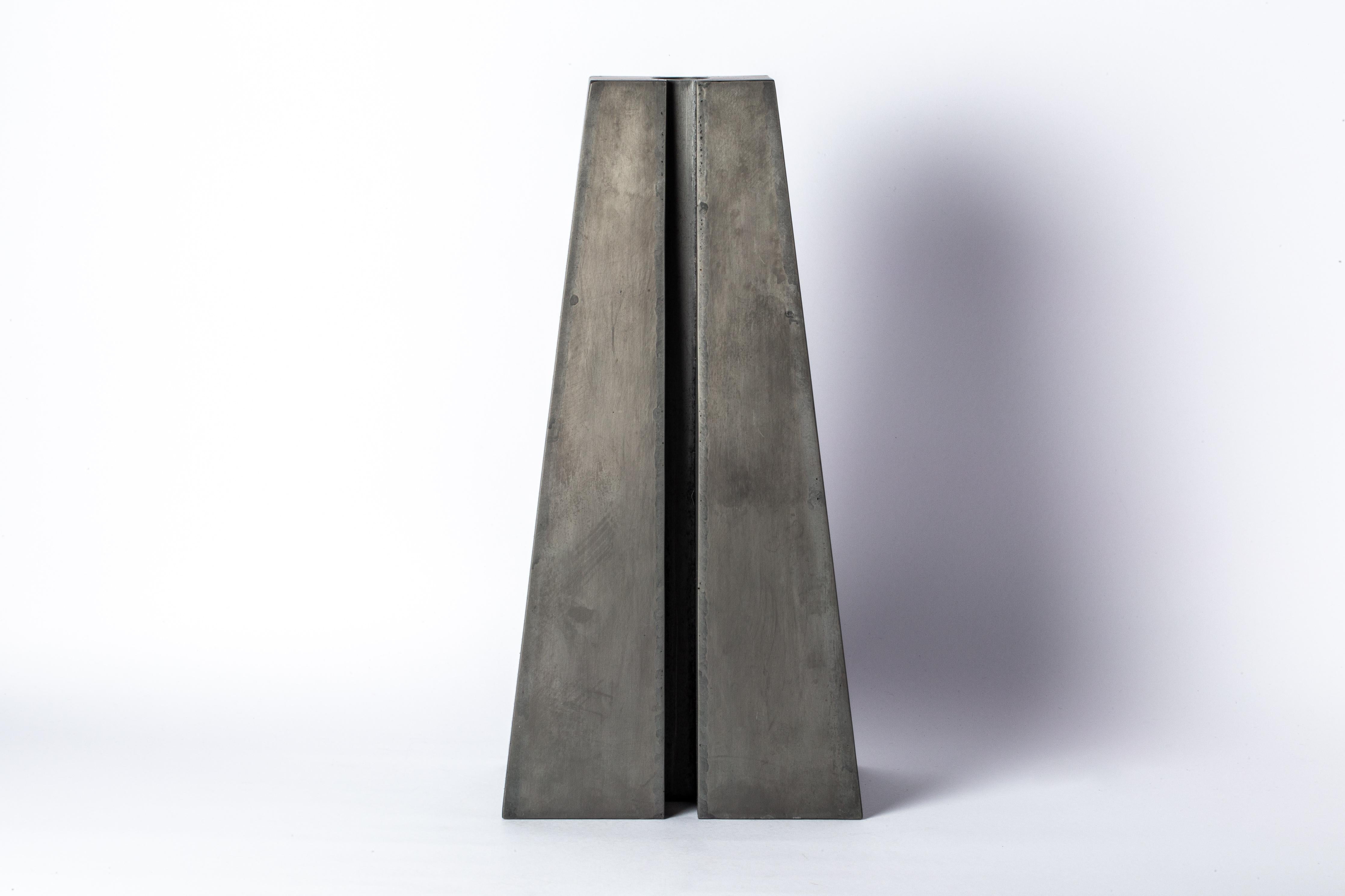 Candle Tower in iron. It showcases a stunning acid oxidation finish. It's more than just a candle holder; it's a captivating work of art that exudes charm and character.