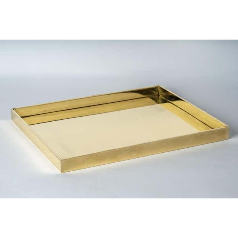 This tray is hand-made in polished brass. Crafted with meticulous care, it is a masterpiece of metalwork. Every inch is a testament to artisanal skill, with each section cut and shaped by hand.