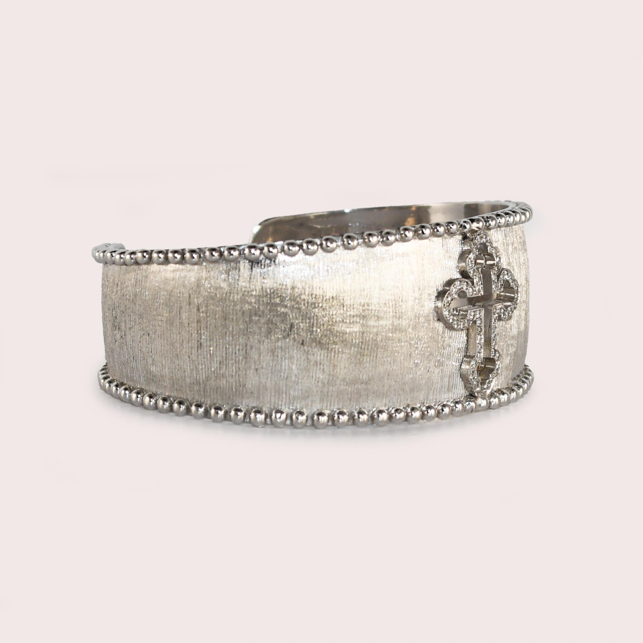 Ladies 18k white gold designer bracelet by Jude Frances.
The bangle tests 18k and weighs 55 grams.
There are round brilliant cut diamonds set in the cross design, .20 to .25 total carats, G to H color, Vs to Si clarity.
Attractive brush finish.
The