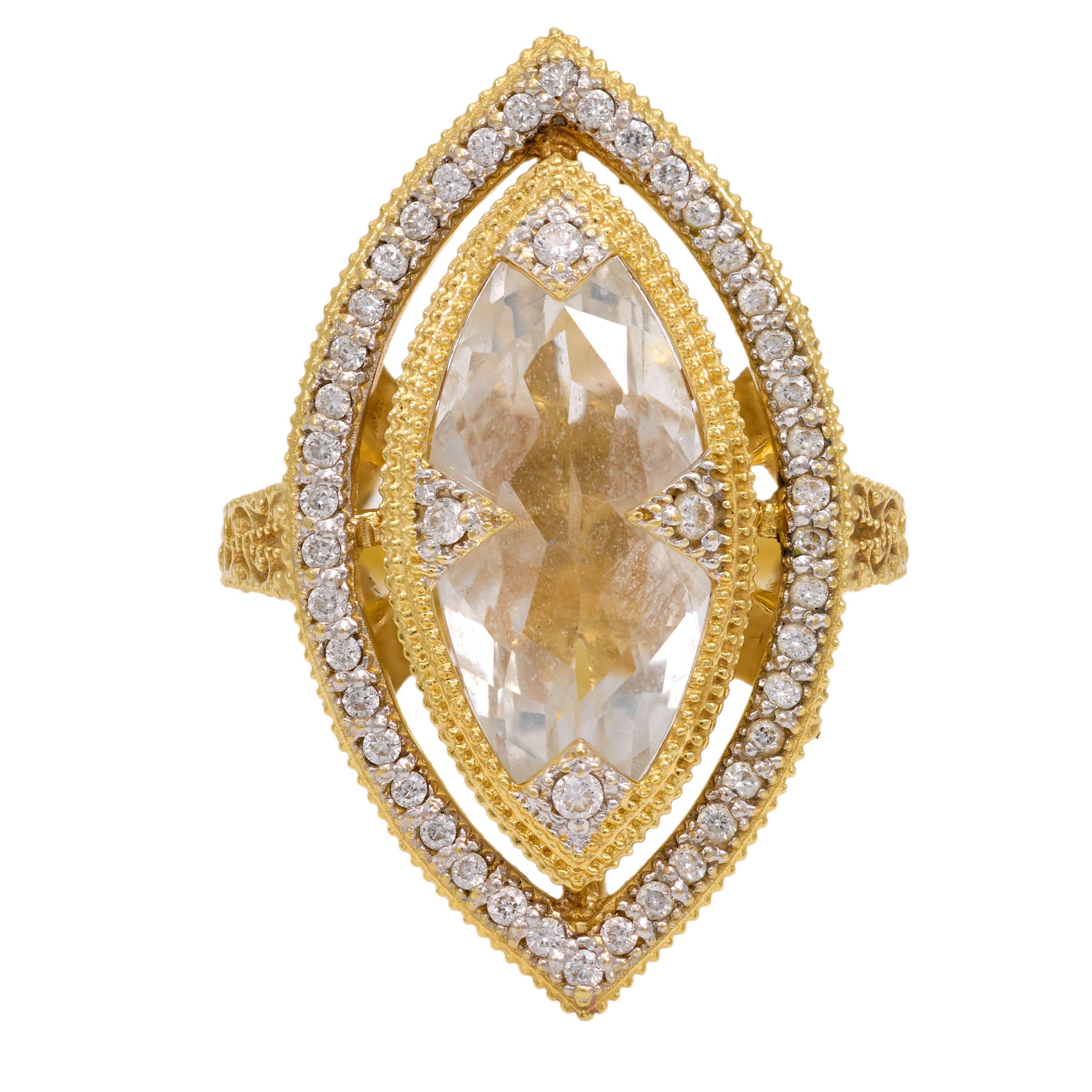 A gorgeous ring by legendary jeweler, Jude Frances! Crafted in vibrant 18k yellow gold, this nanette-style ring features a large, central marquis cut white topaz held within a milgrained bezel setting. The white topaz is brilliantly faceted and is