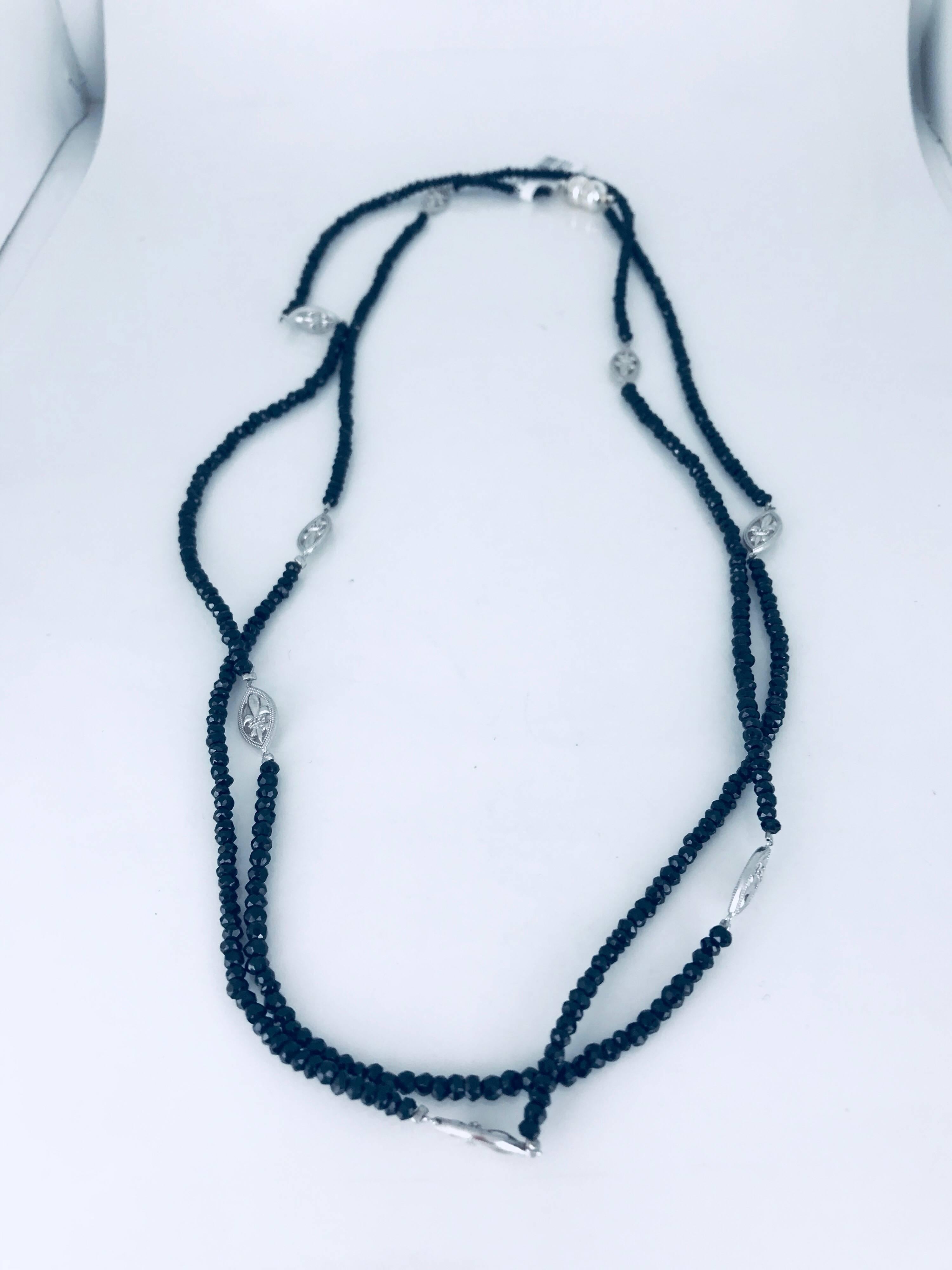 Jude Frances, Fleur De Lis sterling silver, accented necklace with natural beaded black colored, gemstones. The length of the necklace is 47.5 inches with a magnetic clasp. The necklace can be worn a variety of ways, as a choker or opera-length.
The
