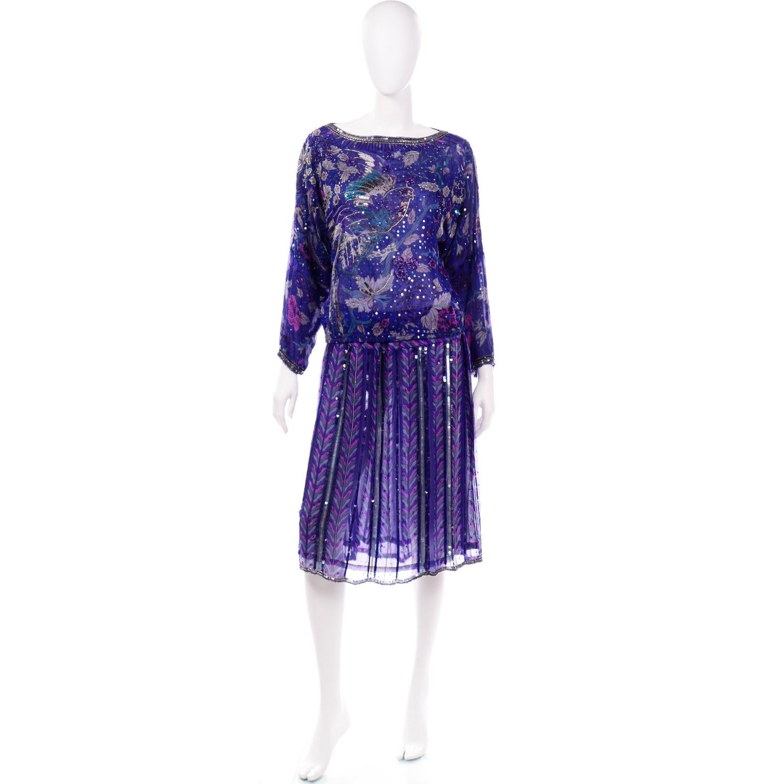 This is a stunning beaded and sequin 2 piece dress from Judith Ann Creations. The outfit includes a gorgeous silk lined long sleeve blouse with a beautiful bird motif. and a silk lined skirt. The top has a wide boat neck that is fully beaded and has