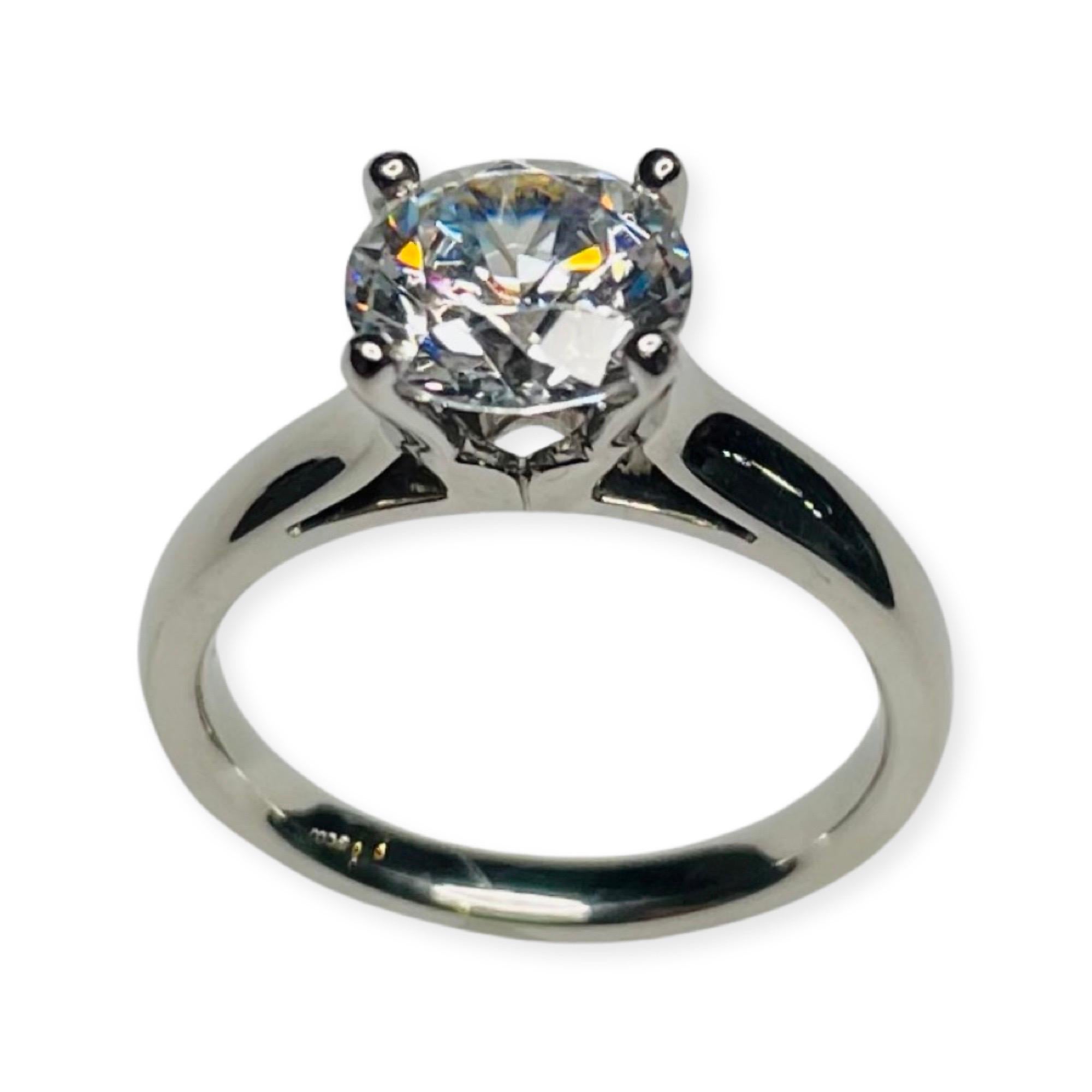 Judith Conway Platinum Engagement Ring with an 8.0 mm Cubic Zirconia Center. This CZ is equivalent to a 2.0 carat diamonds.  The ring is 3.3 mm at the top and tapers to 2.3 mm at the base of the shank. It is finger size 6.75 but can be sized for an