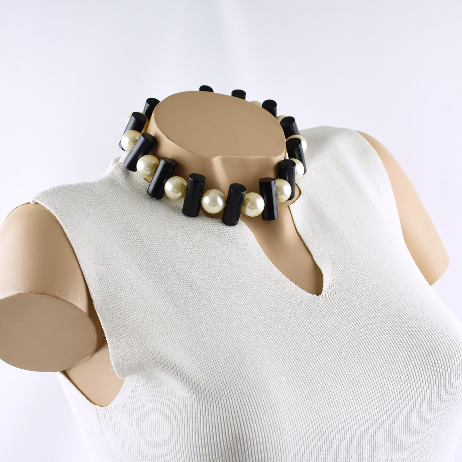Stunning choker necklace by Judith Hendler. This around-the-neck necklace is from the 1980s and features acrylic or Lucite geometric black stick beads compliment with huge pearl imitation beads. Just an amazing rare piece.
Measurements: necklace