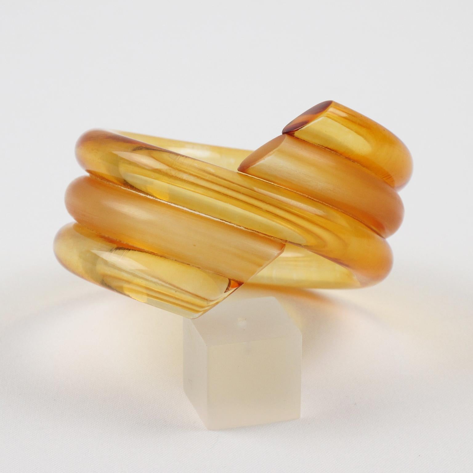 Elegant Judith Hendler Lucite or Acrylic bracelet bangle. This bracelet is transparent frosted and transparent clear with a coiled design in lovely warm orange marigold color. 
Measurements: inside across is 2.63 in. diameter (6.7 cm) - outside