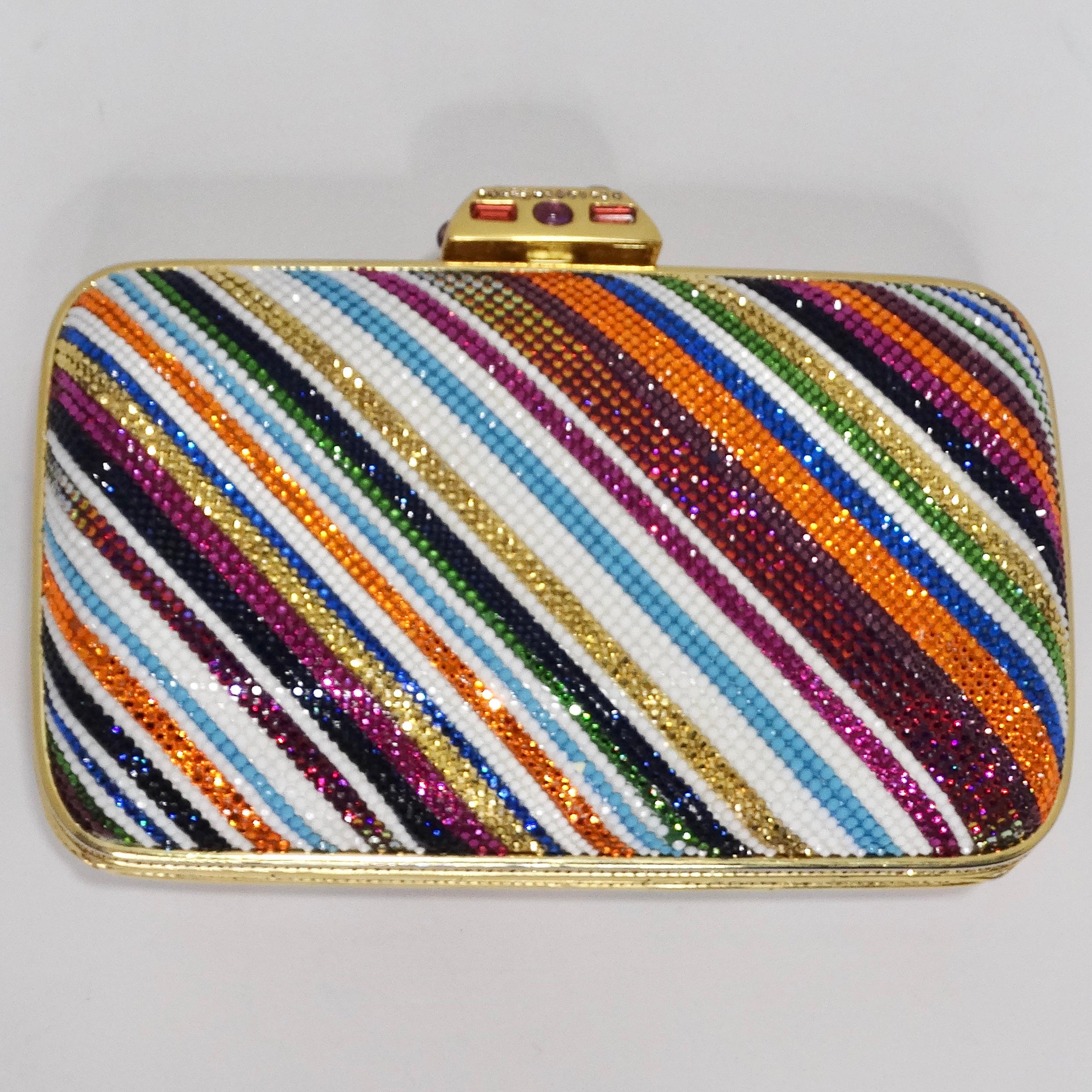 Elevate your accessory game with the mesmerizing Judith Leiber Rainbow Swarovski Crystal Clutch. This iconic piece is a dazzling work of art that's bound to steal the spotlight. Crafted to perfection, the clutch is adorned with a vibrant array of