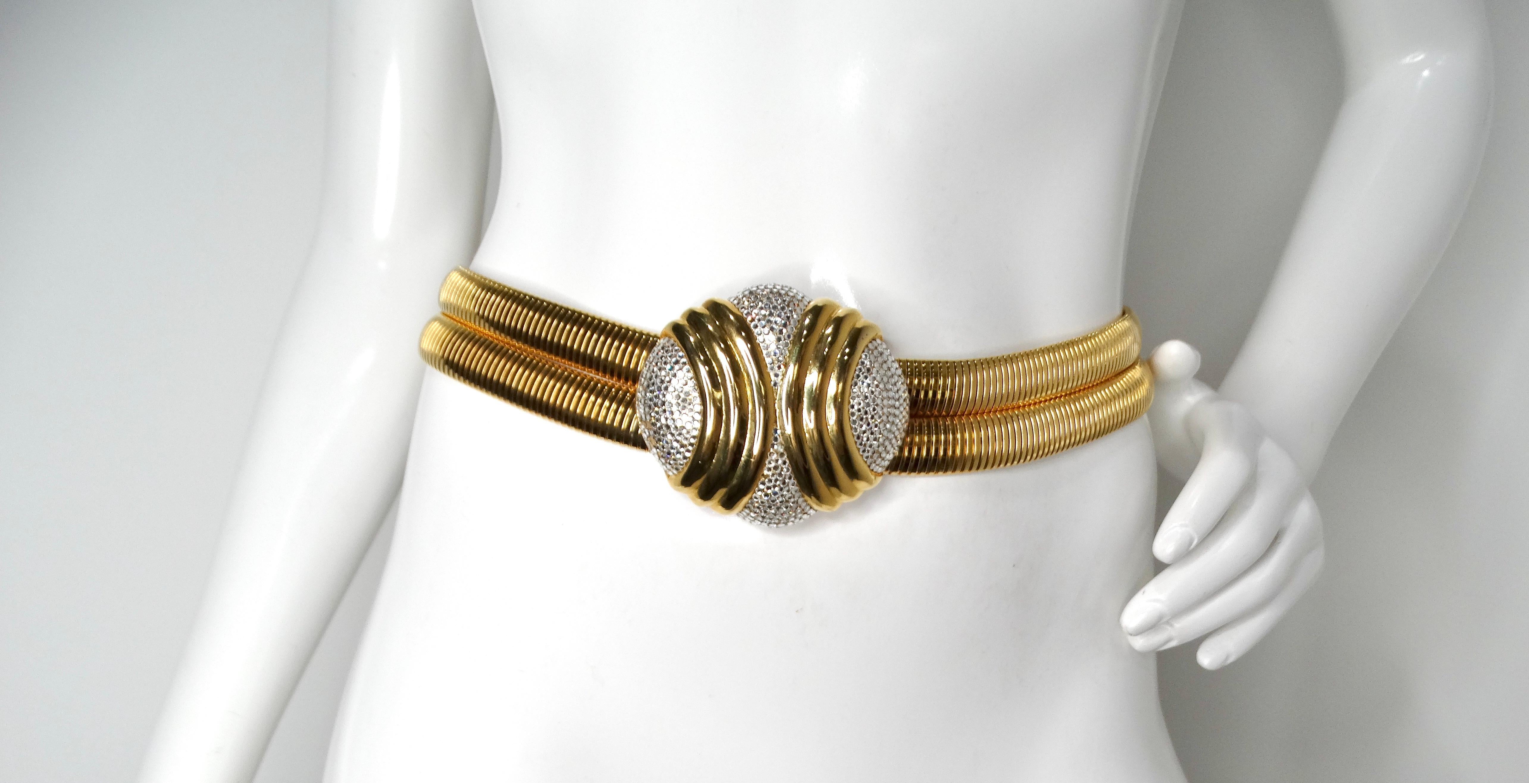 Introducing the iconic Judith Leiber 1980s Gold-Tone Stretch Double Belt with Rhinestone Buckle, a stunning accessory that epitomizes vintage glamour and sophistication. This exquisite belt features a luxurious gold-tone finish combined with an