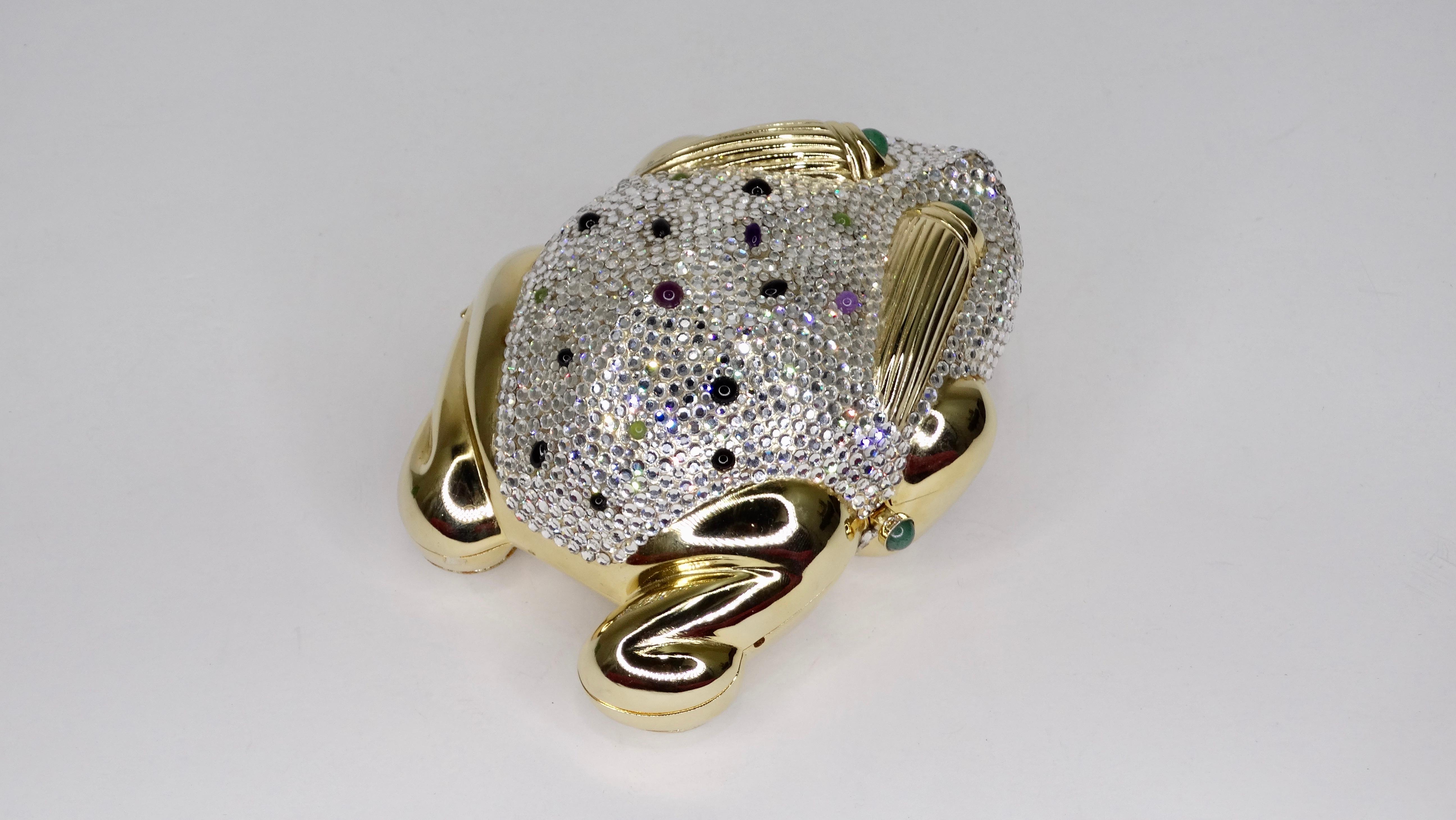 Add this amazing piece to your collection! Circa 1980s, this Judith Leiber frog miniaudiere features multi color Jade, Amethyst and Onyx stones with a push-lock closure. Gold Plated hardware encrusted with Austrian Swarovski Crystals. Judith Leiber