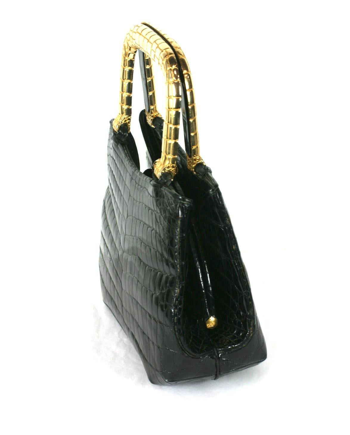 Chic and charming Judith Leiber Alligator Bag with Gilt Handles. High quality center cut black skin with gilded handles embossed with a crocodile pattern.  1980's USA-Italy. 1970's.
Gilt embossed 