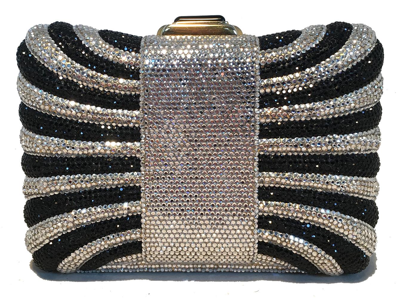 Judith Leiber Black and Silver Swarovski Crystal Minaudiere Evening Bag Clutch in excellent condition. Black and Silver swarovski crystal exterior with gold hardware trim. Top button closure opens to a gold leather interior that holds an attached