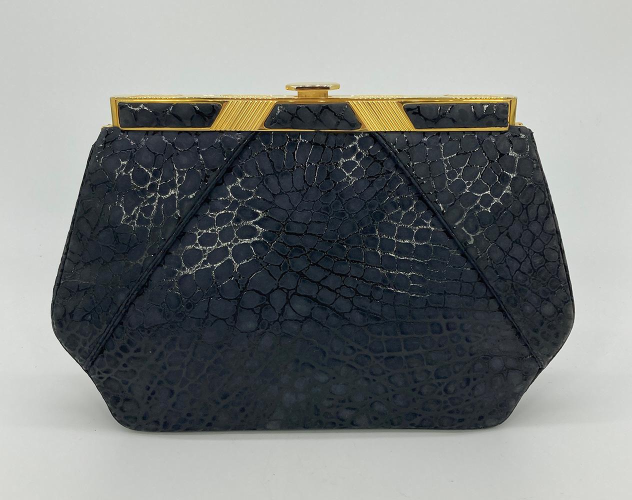 Judith Leiber Black Embossed Alligator Clutch in excellent condition. Black embossed suede exterior in an alligator print trimmed with gold hardware. Top button closure opens to a black nylon interior with one slit and one zipped side pockets.