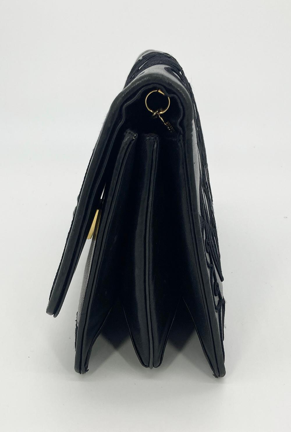 Judith Leiber Black Embroidered Leather Tassel Clutch in very good condition. Black lambskin exterior with unique embroidery, black tassel side detail and front black and gold hardware. Front latch flap closure opens to a black nylon interior with 3