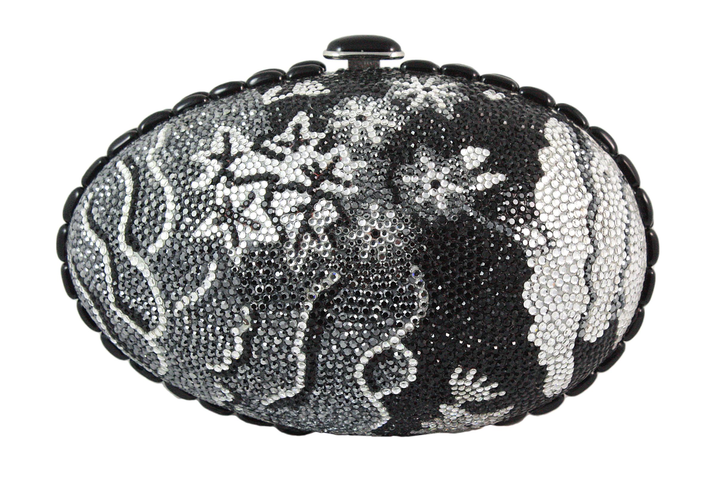 Judith Leiber clutch 
Black, grey, and silver rhinestones in a floral design 
Black and silver snap closure 
Black trim around the egg 
Silver chain strap that can be stored inside 
Soft silver leather lining
Comes with silver coin purse, mirror,