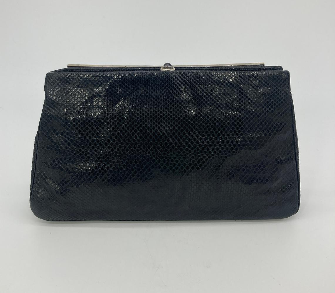 Judith Leiber Black Lizard Antique Silver Fish Crystal Hardware Clutch in excellent condition. Black lizard exterior trimmed with antique silver hardware in a unique fish design with crystals and gemstones throughout. Two exterior side slit pockets.