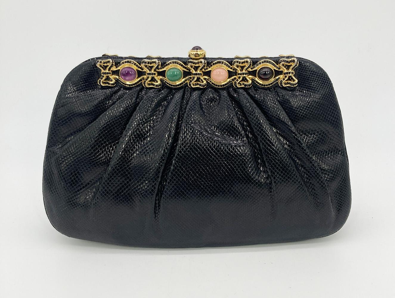 Judith Leiber Black Lizard Black Crystal Multi Color Gemstone Clutch in good condition. Black lizard exterior trimmed with gold hardware, black crystals and multi color gemstones along top edges. Top button closure opens to a black nylon interior