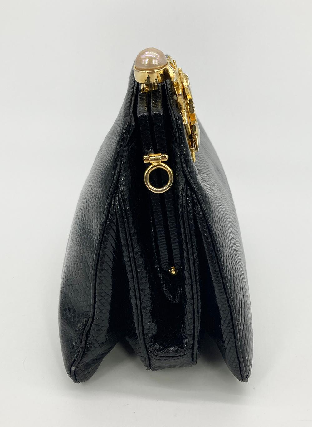 Judith Leiber black Lizard Gold Crystal Star Clutch in very good condition. Black lizard leather trimmed with gold hardware. Unique gold star cluster along top right corner with clear swarovski crystals throughout. Top pearl coated button closure