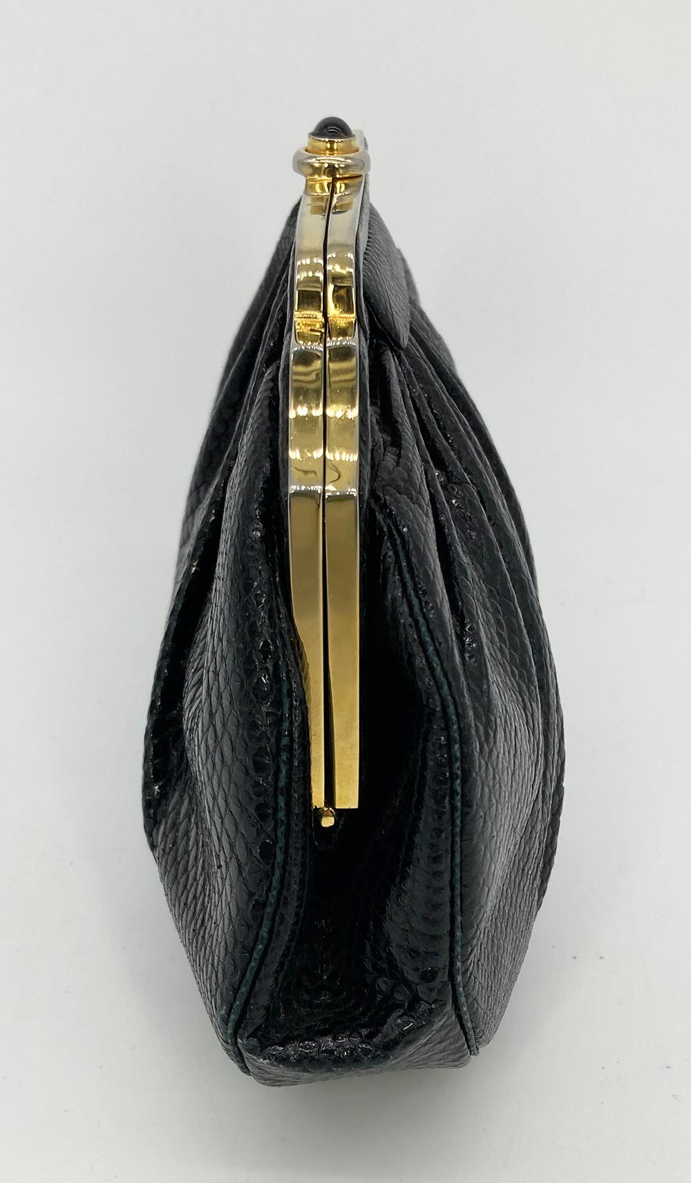 Judith Leiber Black Lizard Gold Deco Top Edge Clutch in very good condition. black lizard leather trimmed with a gold deco designed top edge. centered top button closure opens to a black satin interior with one slit and one zip side pocket and