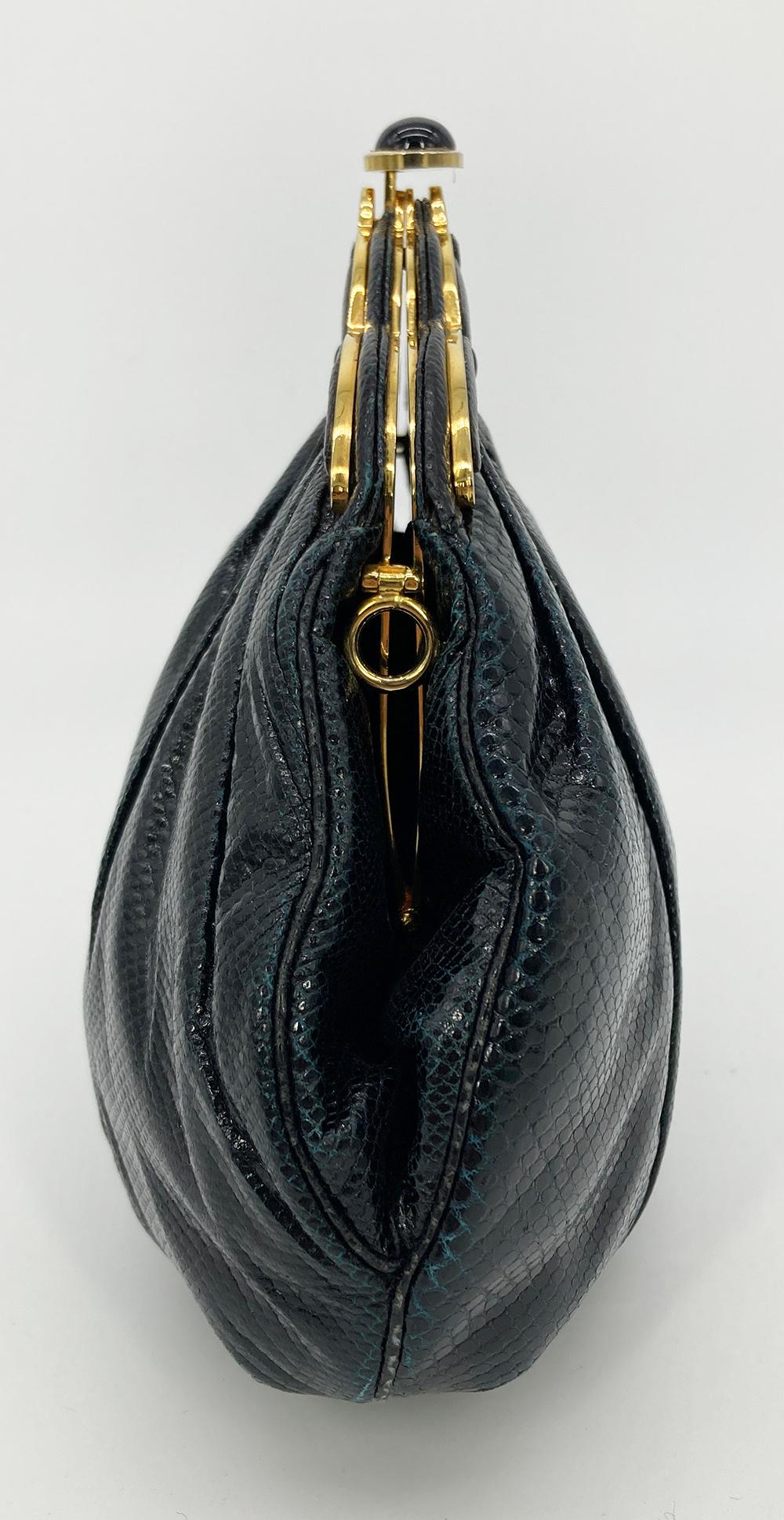 Judith Leiber Black Lizard Gold Scallop Top Clutch in good condition. Black lizard exterior trimmed with gold hardware. Top button closure opens to a black nylon interior with one slit and one zip side pockets and attached lizard shoulder strap to