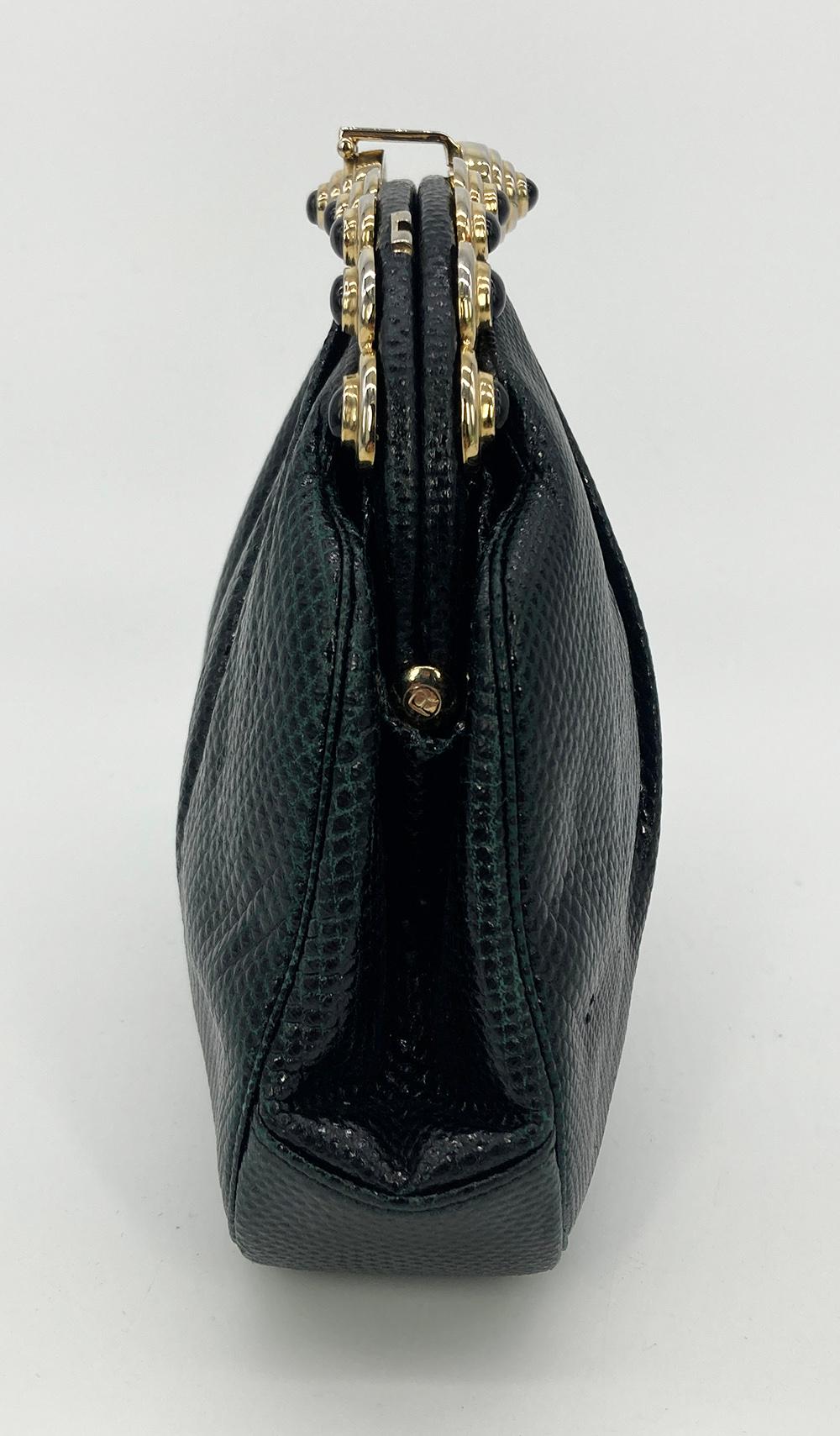 Judith Leiber Black Lizard Gold Top Black Stone Clutch in good condition. Black lizard exterior trimmed with gold hardware and black gemstones along top edge. Lift latch closure opens to a black nylon interior with 2 side slit pockets and attached