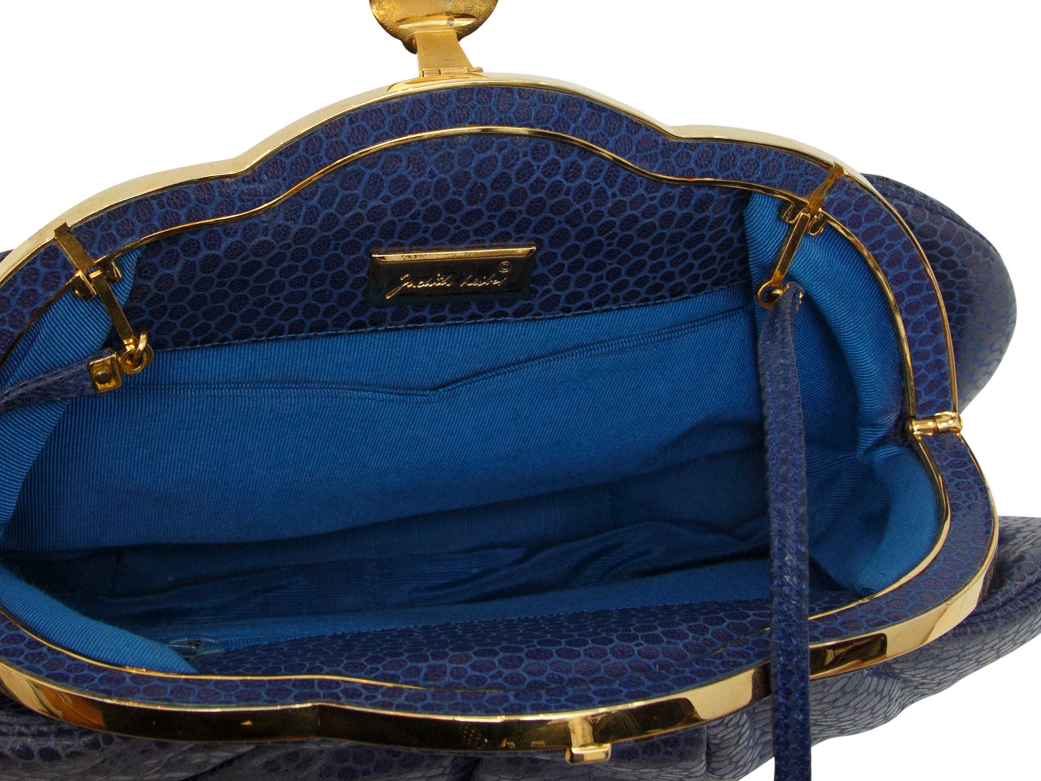 Product details: Blue reptile clutch by Judith Leiber. Gold-tone hardware. Detachable shoulder strap. Interior pocket. Embellished closure at front. 11