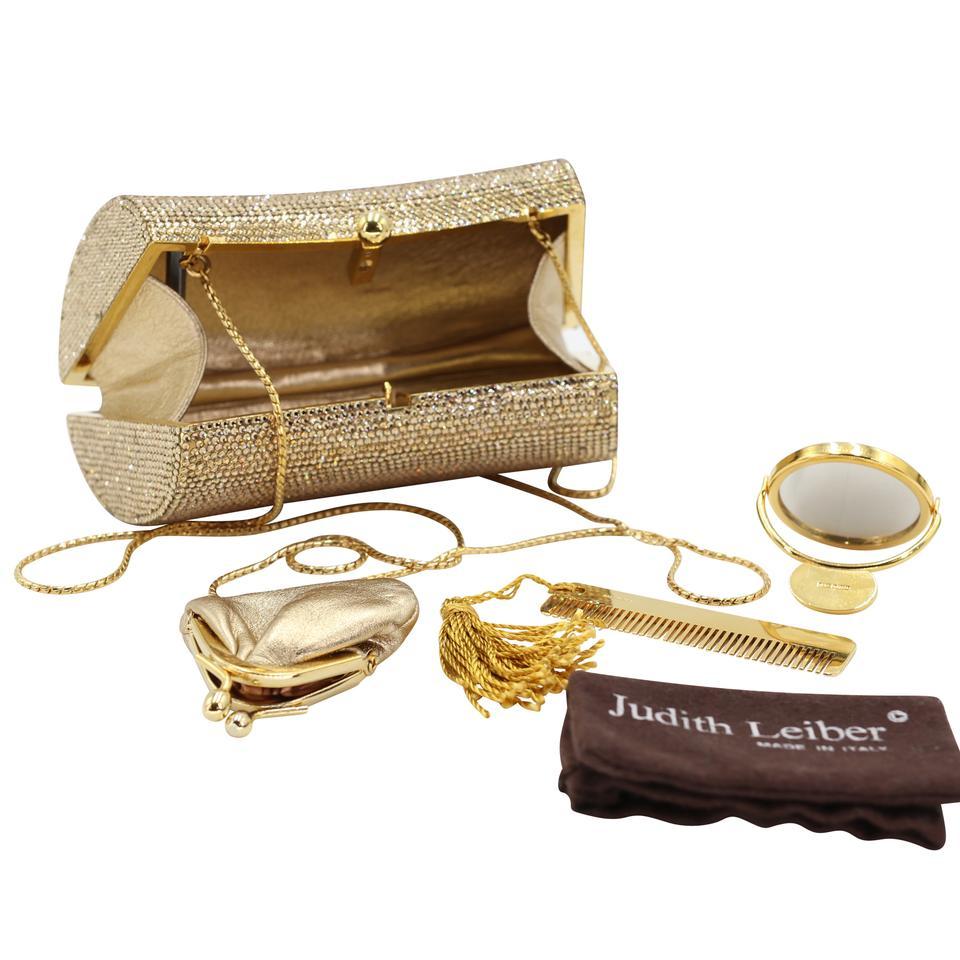 Judith Leiber elegant gold crystal minaudiere with foldable gold chain strap. This beautiful collection is extremely rare and completely sold out!!! This stunning evening clutch/crossbody bag entirely encrusted with miniature crystals. The bag