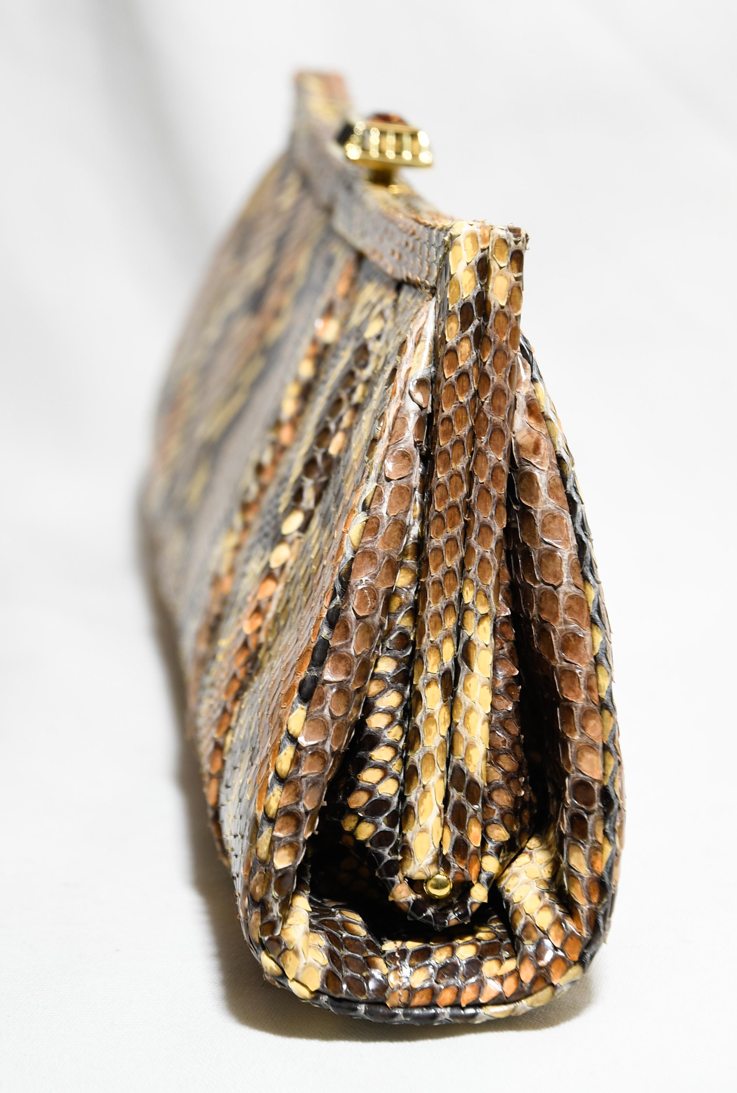 Judith Leiber brown, beige and orange pleated python bag can be worn as a clutch or a shoulder bag.  A brown jeweled push lock  at top of snakeskin frame, for closure.  This pleated snakeskin clutch is dramatic and can be paired with many ensembles