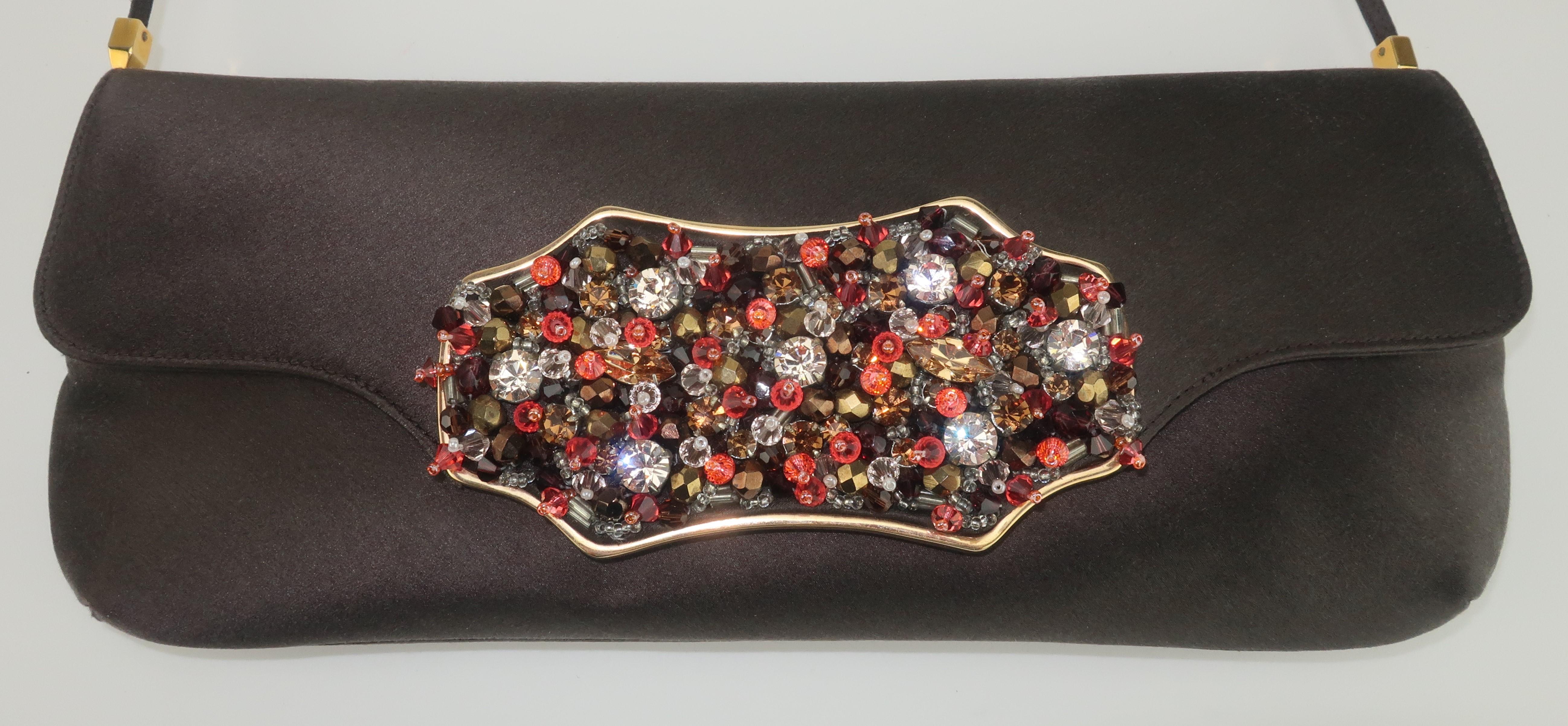 Lovely Judith Leiber dark brown satin evening handbag with an envelope style silhouette and a front flap embellished with an array of beading and crystal rhinestones in shades of orange, amber, brown topaz and silvery crystal all set in a gold tone