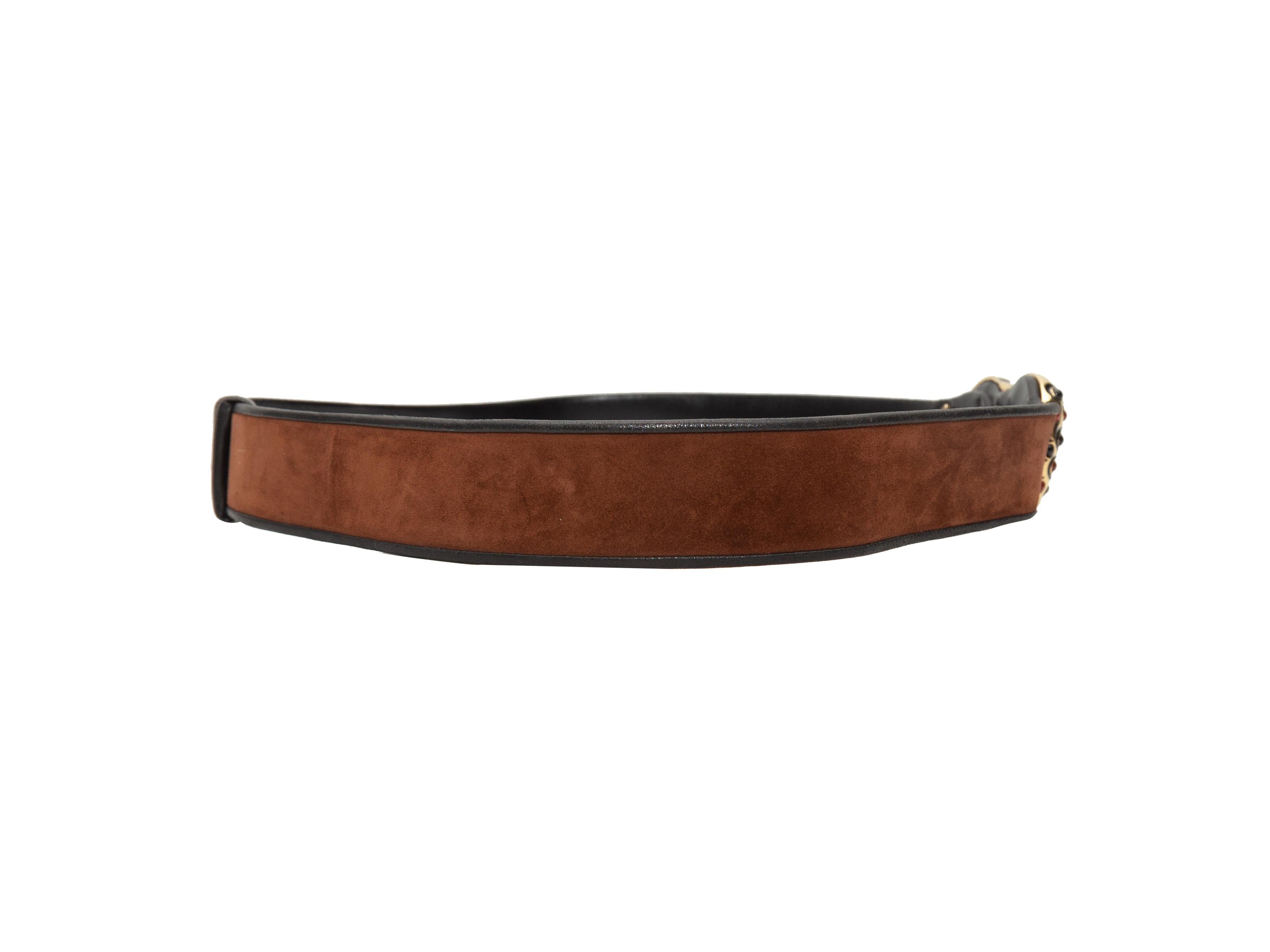 Product details: Brown suede waist belt by Judith Leiber. Black leather trim. Gold-tone zebra and leopard motif buckle closure. 1.5