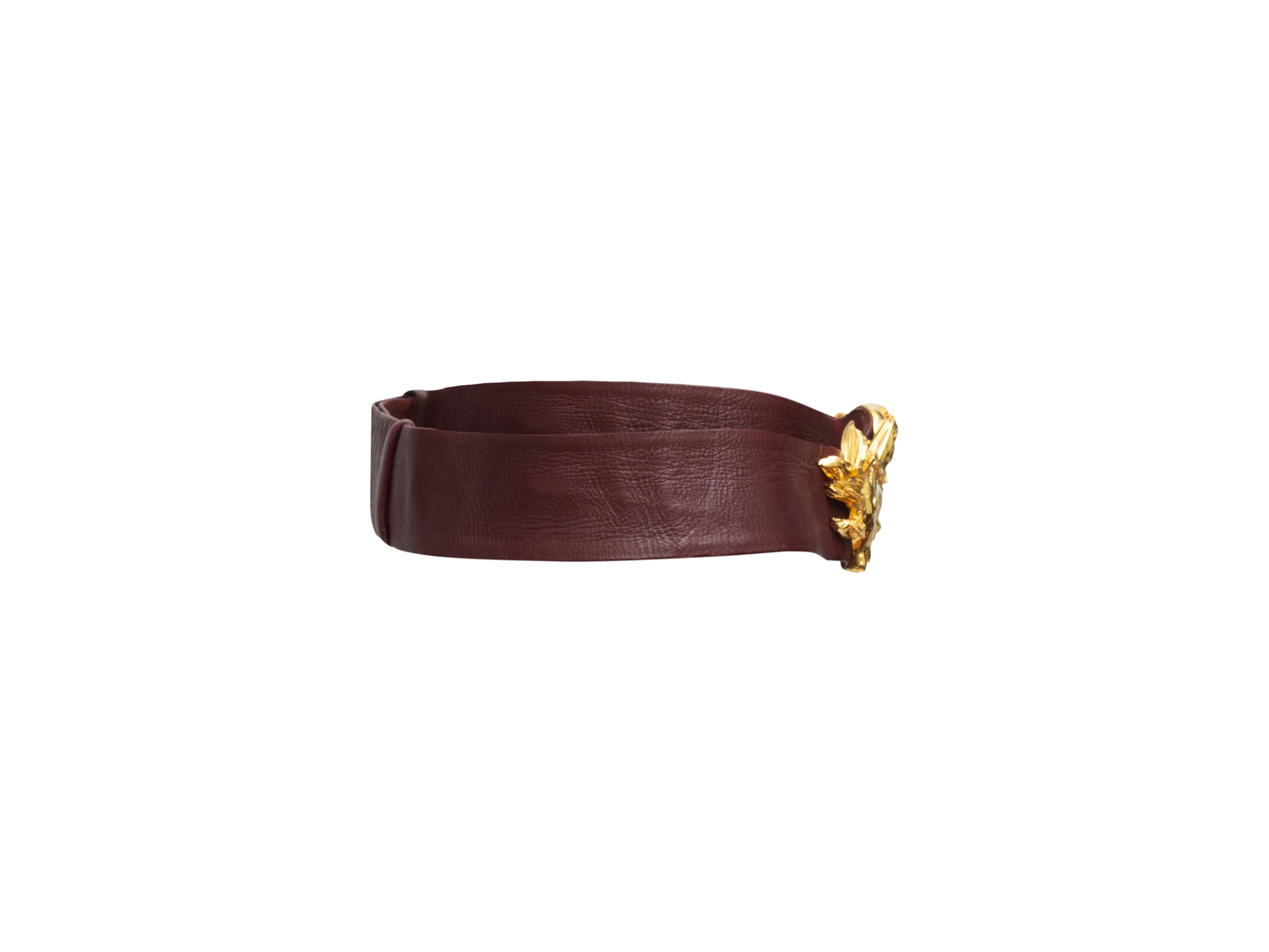 Product details: Burgundy leather waist belt by Judith Leiber. Ornate gold-tone dragon motif buckle closure. 32