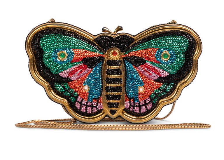 Judith Leiber accessories hold nothing back when it comes to creativity and vivid color. Encrusted in crystals and stones, Leiber’s work immortalizes the various motifs in an array of sparkle and gold. Inspired by the majestic aesthetic of the
