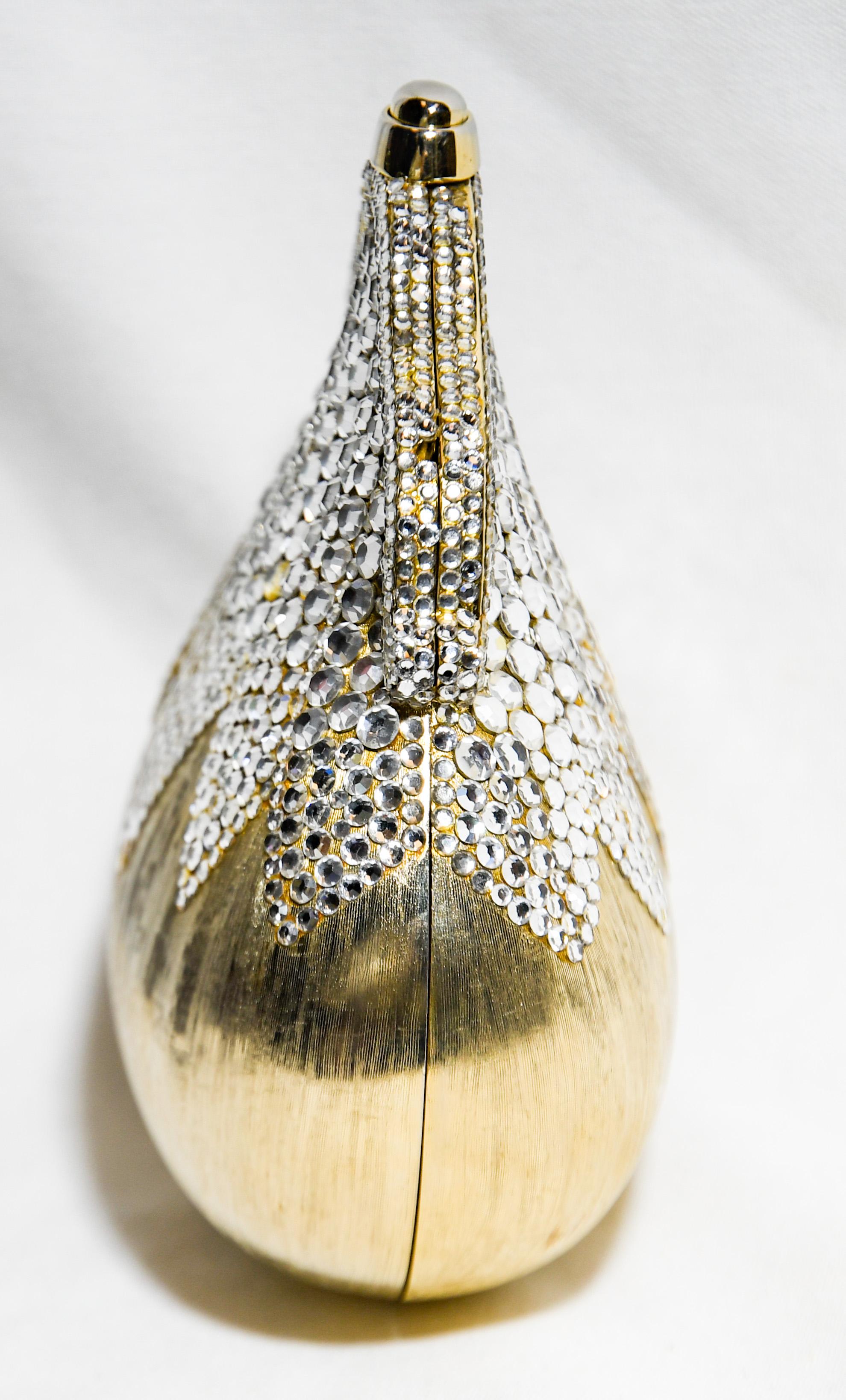 Judith Leiber Chatelaine brilliant gold tone clutch minaudiere should be reserve for that special occasion, but why would you this is a bag to be enjoyed and celebrated. The exterior of this clutch is encrusted with Swarovski crystals cascading down