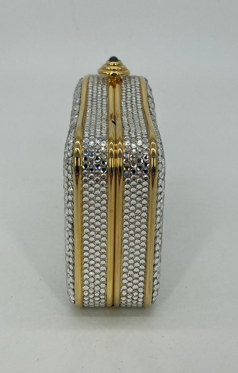 Judith Leiber Crystal Curved Top Small Minaudiere in excellent condition. clear crystals with gold hardware and purple gemstone top button closure. gold leather interior with attached gold chain shoulder strap. No stains smells or missing crystals.