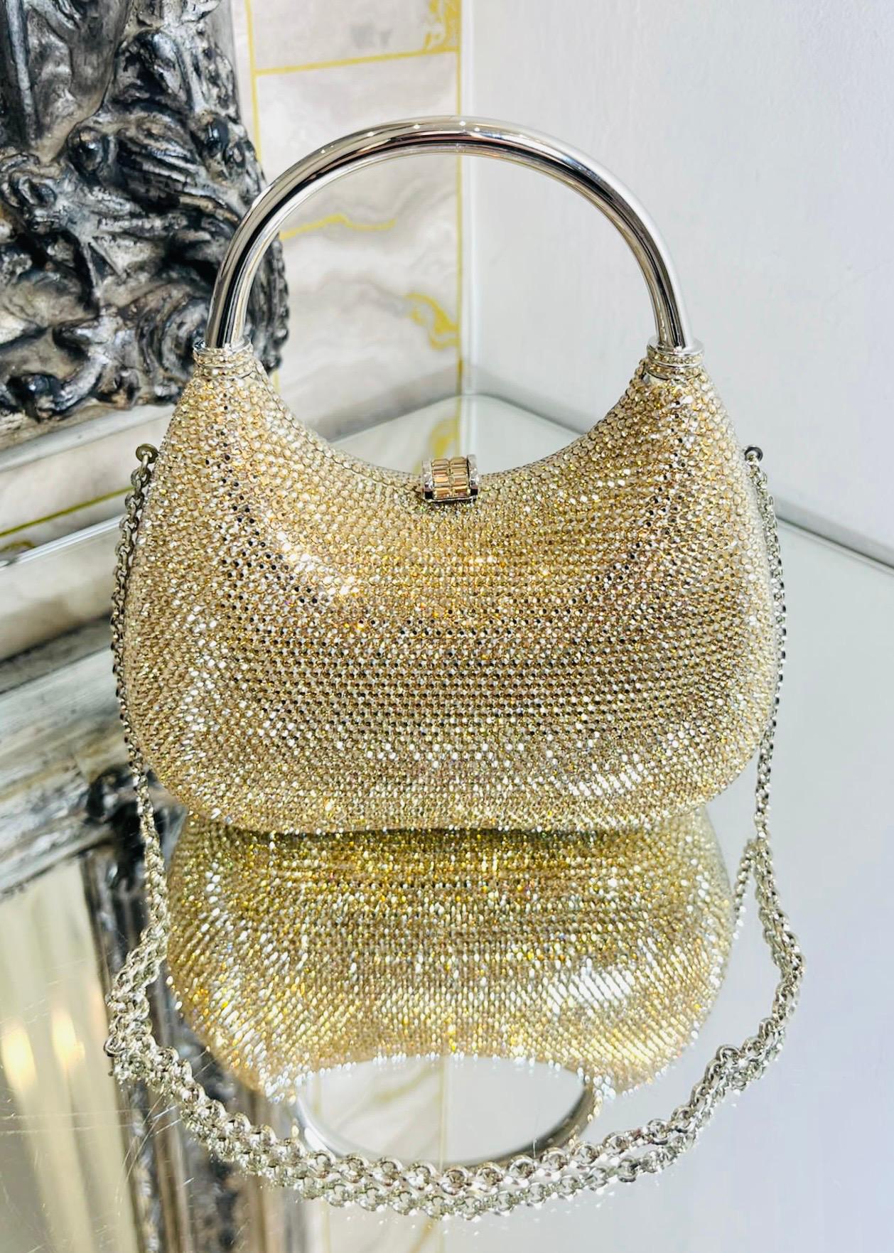 Judith Leiber Crystal Embellished Evening Bag

Gold, hobo-shaped clutch bag adorned with crystals throughout and silver metal top handle.

Featuring gold chain shoulder strap and push down closure leading to metallic silver leather interior. Rrp