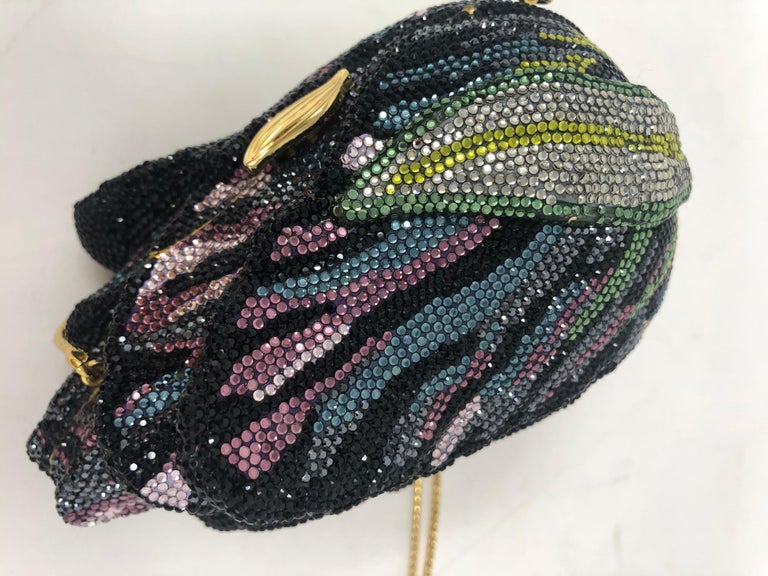Judith Leiber Tulip Minaudiere filled with crystals by Swarovski. Stunning art bag with purple and multi-color crystals. Gold hardware. Can be worn as a clutch or a shoulder bag with gold chain. Includes mirror and comb with certificate of