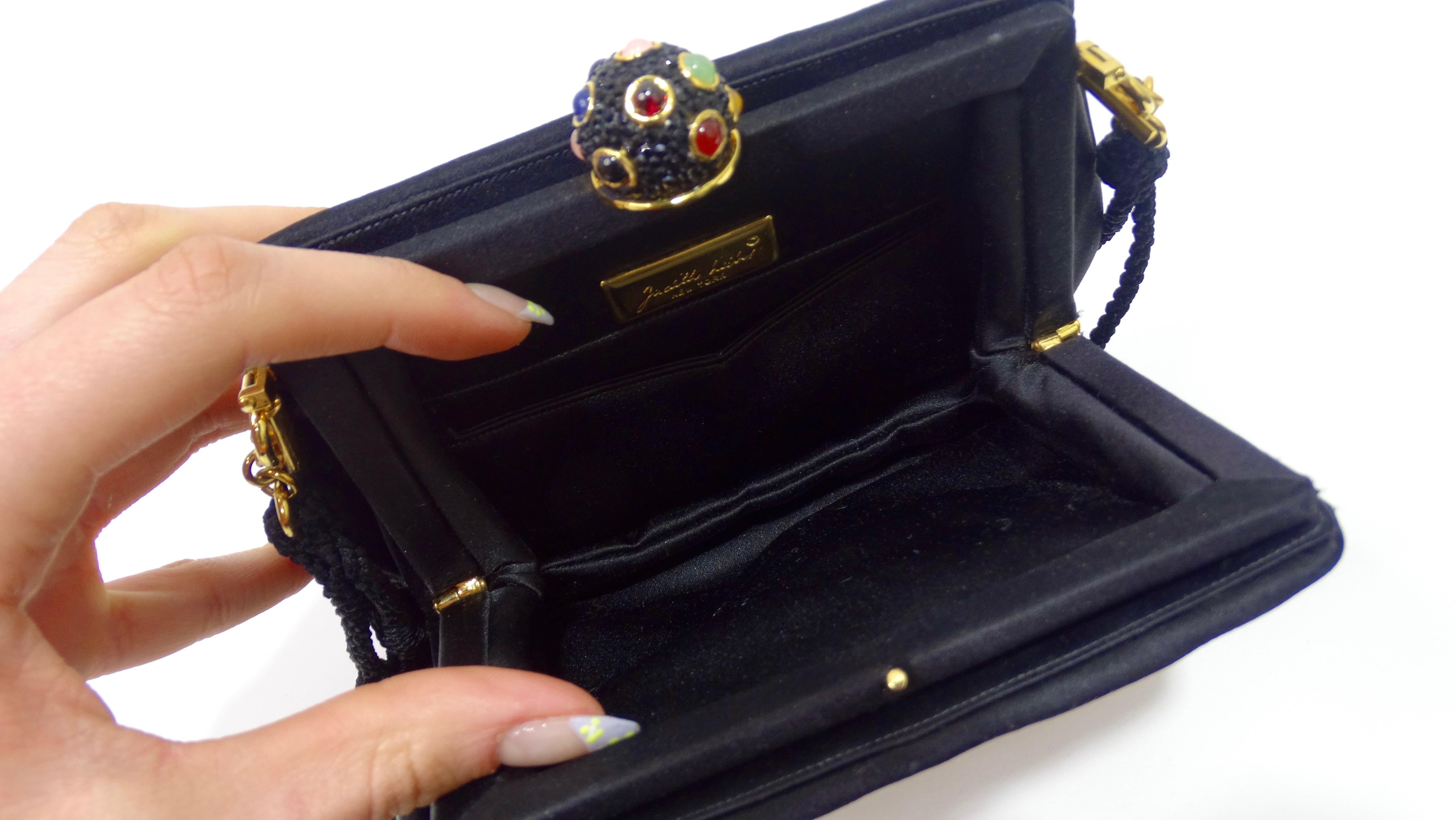 Elevate your look with this amazing Leiber! Circa 1970s, this bag features a gorgeous patchwork motif with colorful rhinestone embellishing, a removable black rope shoulder strap, and a cabochon top closure. Interior is lined with black satin and