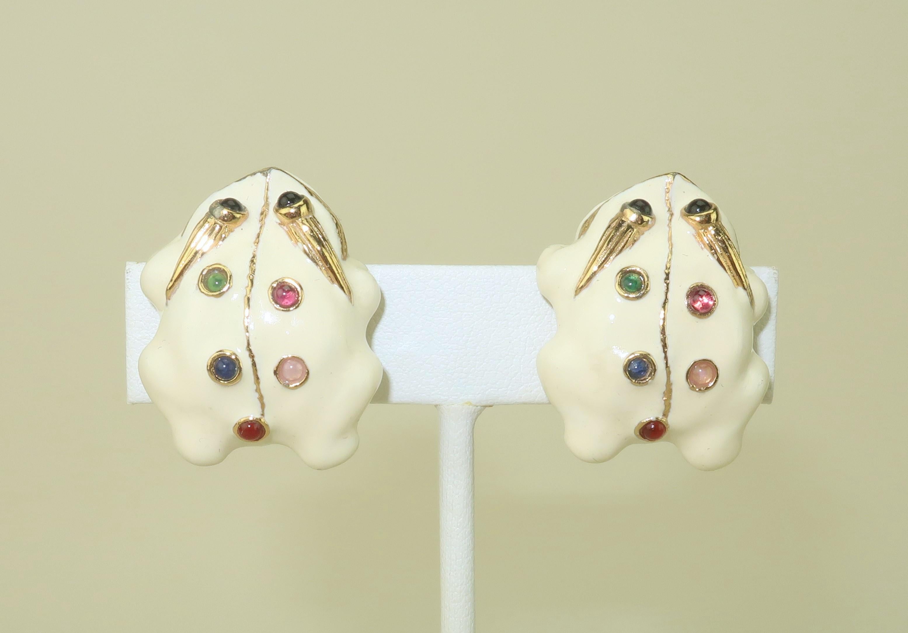 Jump for joy over a precious pair of Judith Leiber enamel frog clip-on earrings.  The gold plated earrings are decorated with ivory color enameling and glass cabochon stones in shades of pink, green, blue, black and red.  The clip on hardware is a