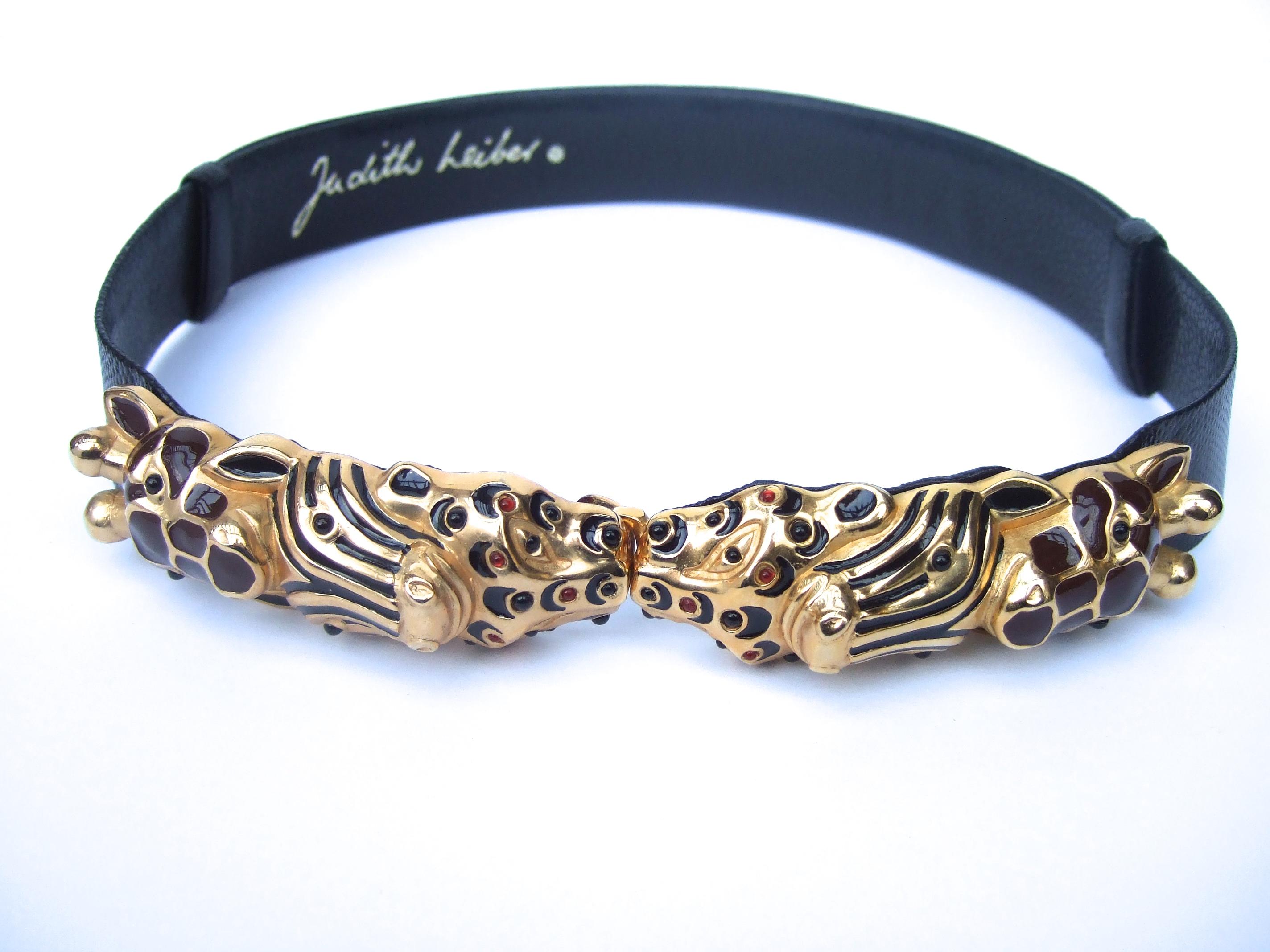 Judith Leiber Glass jeweled jungle animal black leather embossed belt c 1980s

The elegant belt is designed with a collection of exotic jungle animal that serves as the buckle. A panther, zebra & a giraffe

The series of animal heads are sheathed in