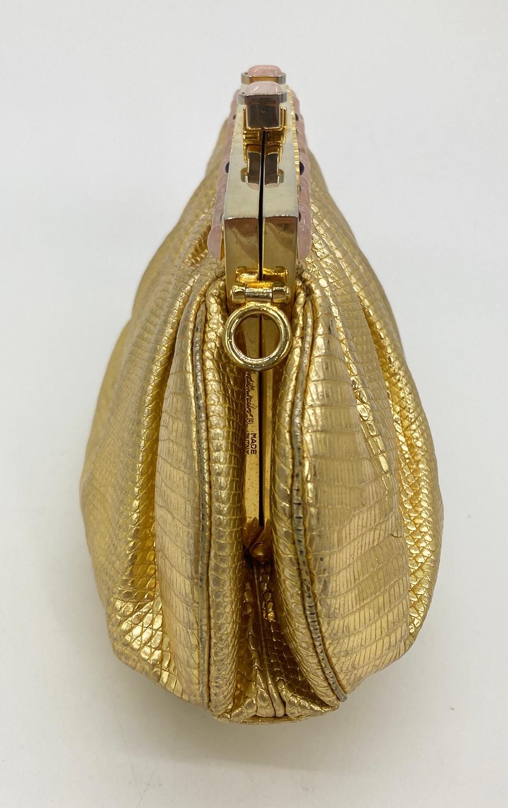 Judith Leiber Gold Lizard Gemstone Clutch in good condition. Gold lizard trimmed with gold hardware, rose quartz and multi color gemstones along top edge. Top pinch lock closure opens to a peach satin lined interior with one slit and one zip side