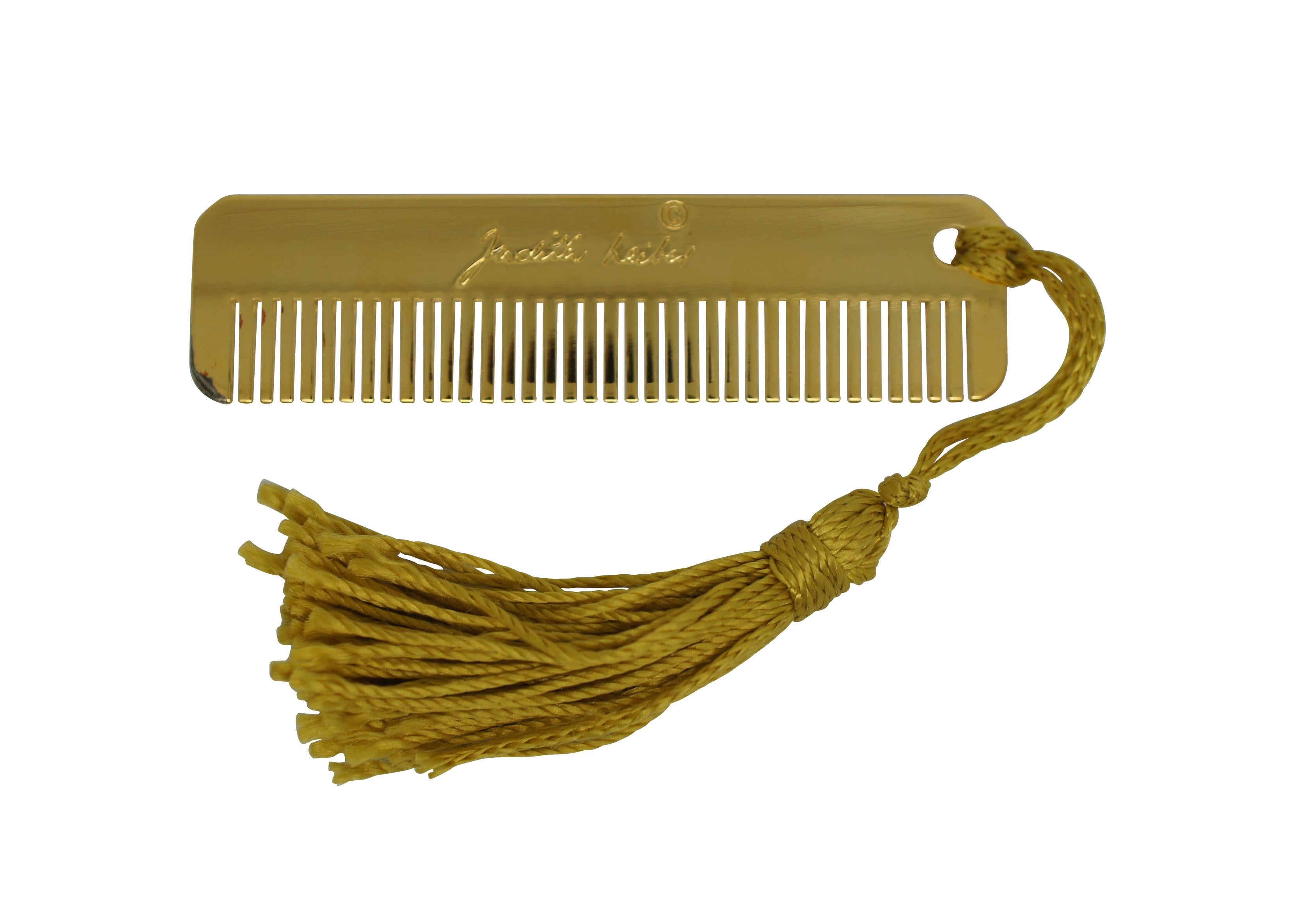 Late 20th century pair of Judith Leiber purse accessories in bright gold plated metal - one pocket comb with tassel and one clip key chain / fob with round jade green stone, capped to resemble an acorn.

Dimensions:
1.125