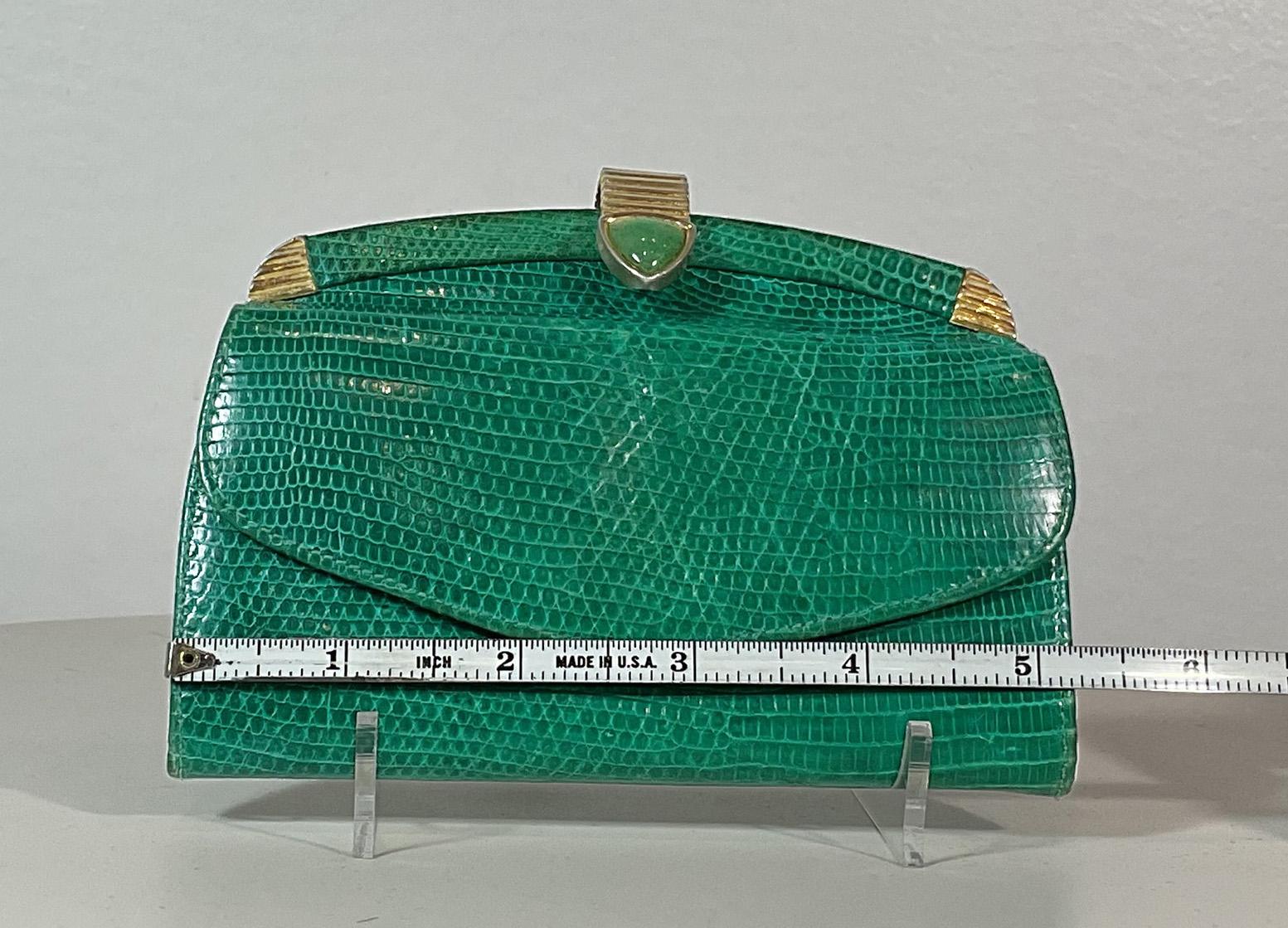 Judith Leiber green lizard skin wallet with gold metal clasp. This wallet is in 'LIKE NEW' condition. There are no significant flaws or wear areas to consider with this lovely wallet. The walet had been very gently used and carefully stored in its