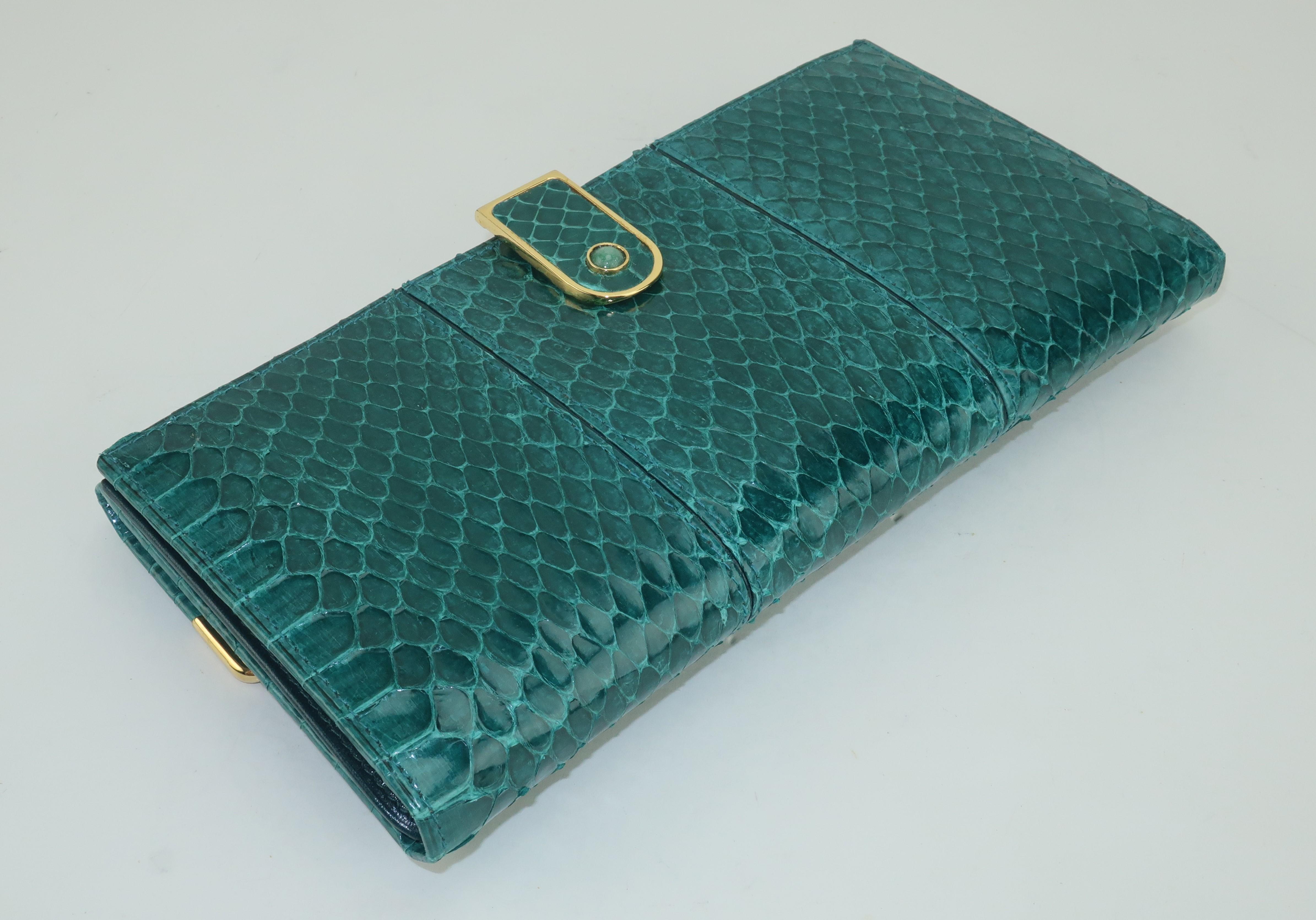 Beautiful Judith Leiber green snakeskin wallet with deep green leather lined interior and gold metal hardware accented with semi precious stones.  The interior opens on one side with a hinged clip and reveals two bill size compartments and a