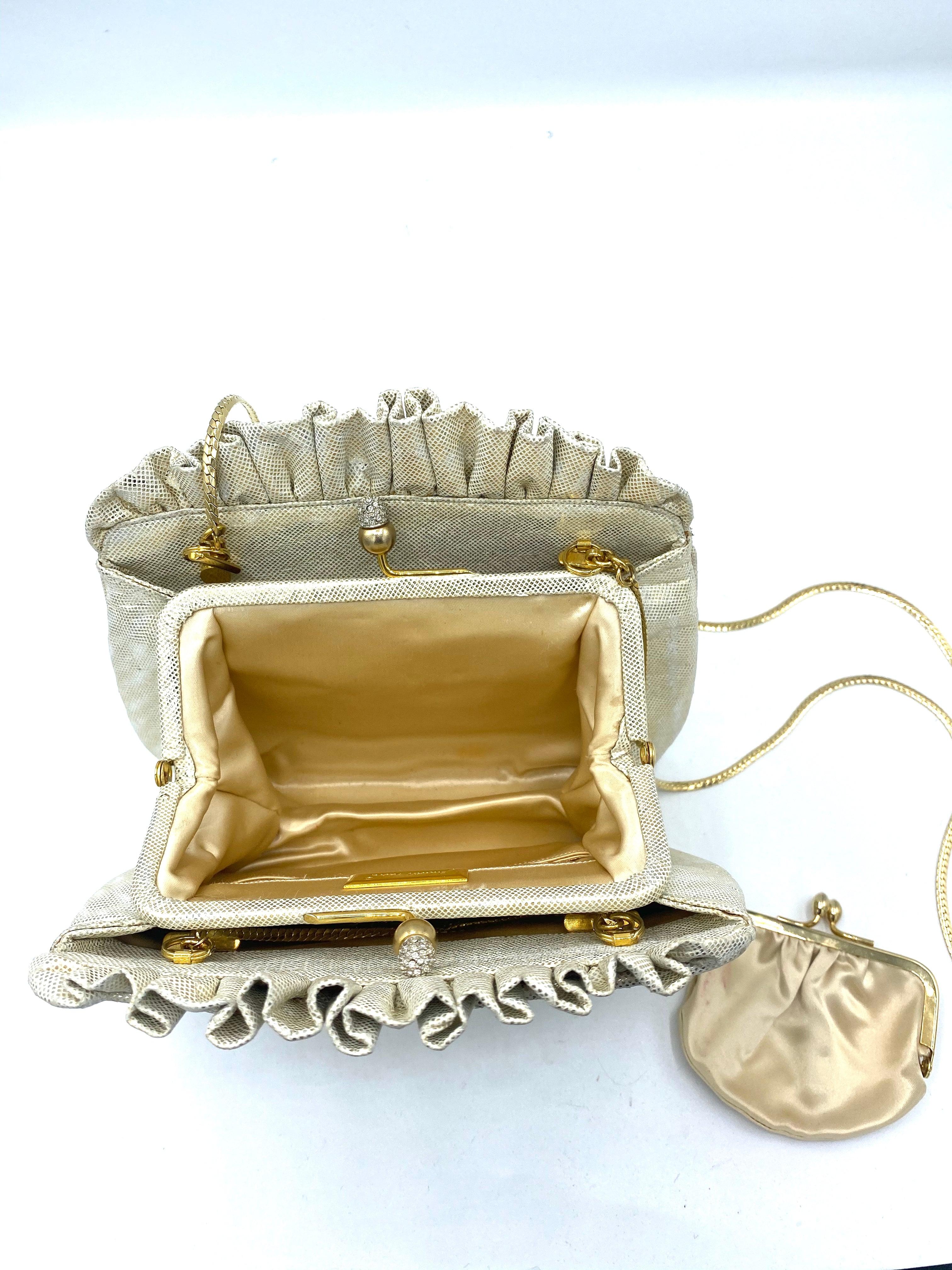 Classic Judith Leiber pouch style evening bag in simulated lizard in gold tone circa 1980s. Ruffles top with rhinestone encrusted kiss lock. Detachable hidden shoulder chain. Comes with original dust bag, change purse and pocket mirror. Excellent