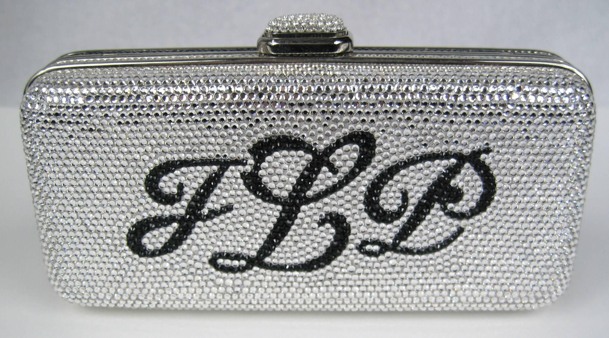 Judith Leiber Monogram Hinged Hard Shell Clutch JLP Double-sided Black and Silver crystals. Measuring  3.5 H x 6 W x 1 3/4 D 50 inch chain. New with Tags. Be sure to check our storefront for more fabulous pieces from this collection. We have been