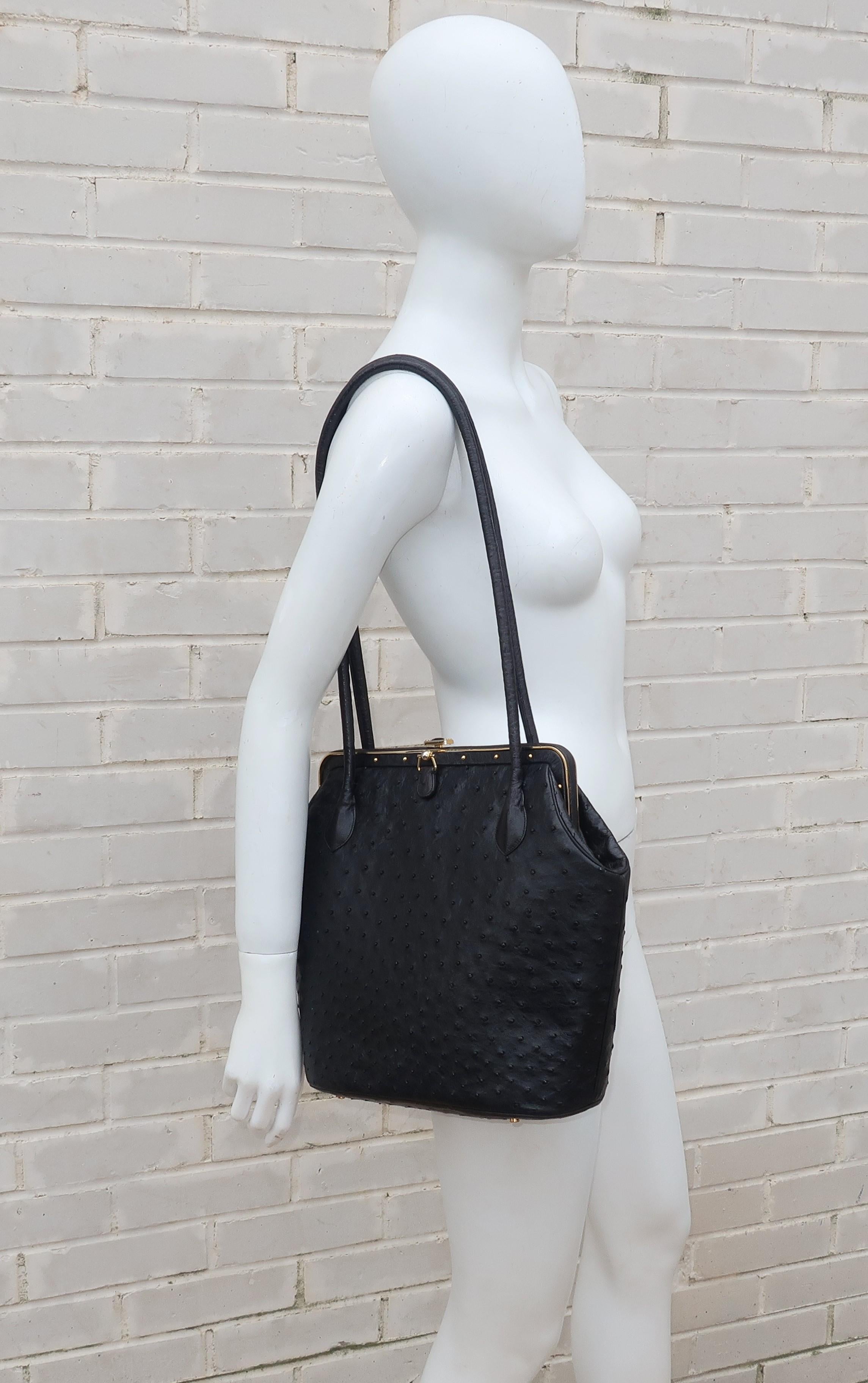 This fabulous Judith Leiber black ostrich handbag is both uncharacteristically large and a little edgy as compared to Leiber's other designs.  The body of the handbag measures 11.5